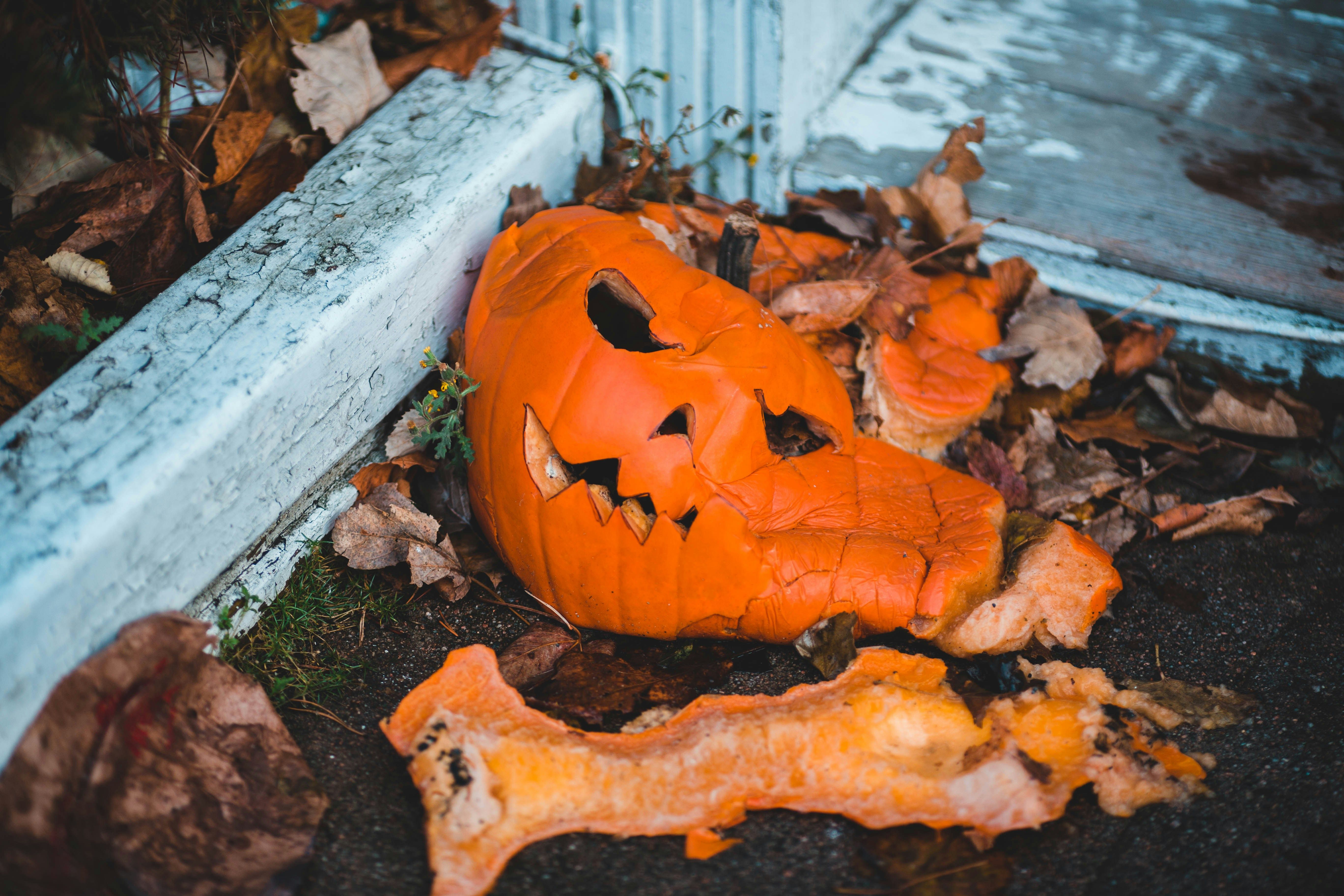 Smashed jack-o'-lantern on a porch step after Mischief Night, illustrating Halloween prank charges and criminal mischief in New Jersey.