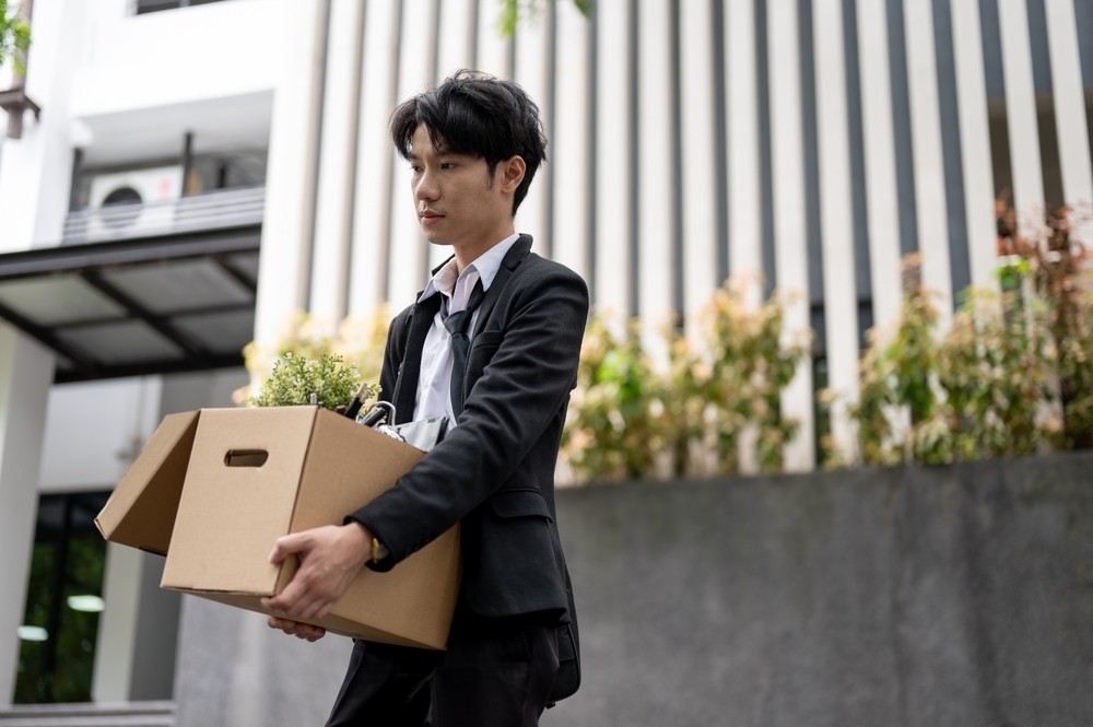 Image Young professional carrying a box after job loss, representing employment consequences after a DUI arrest in New Jersey