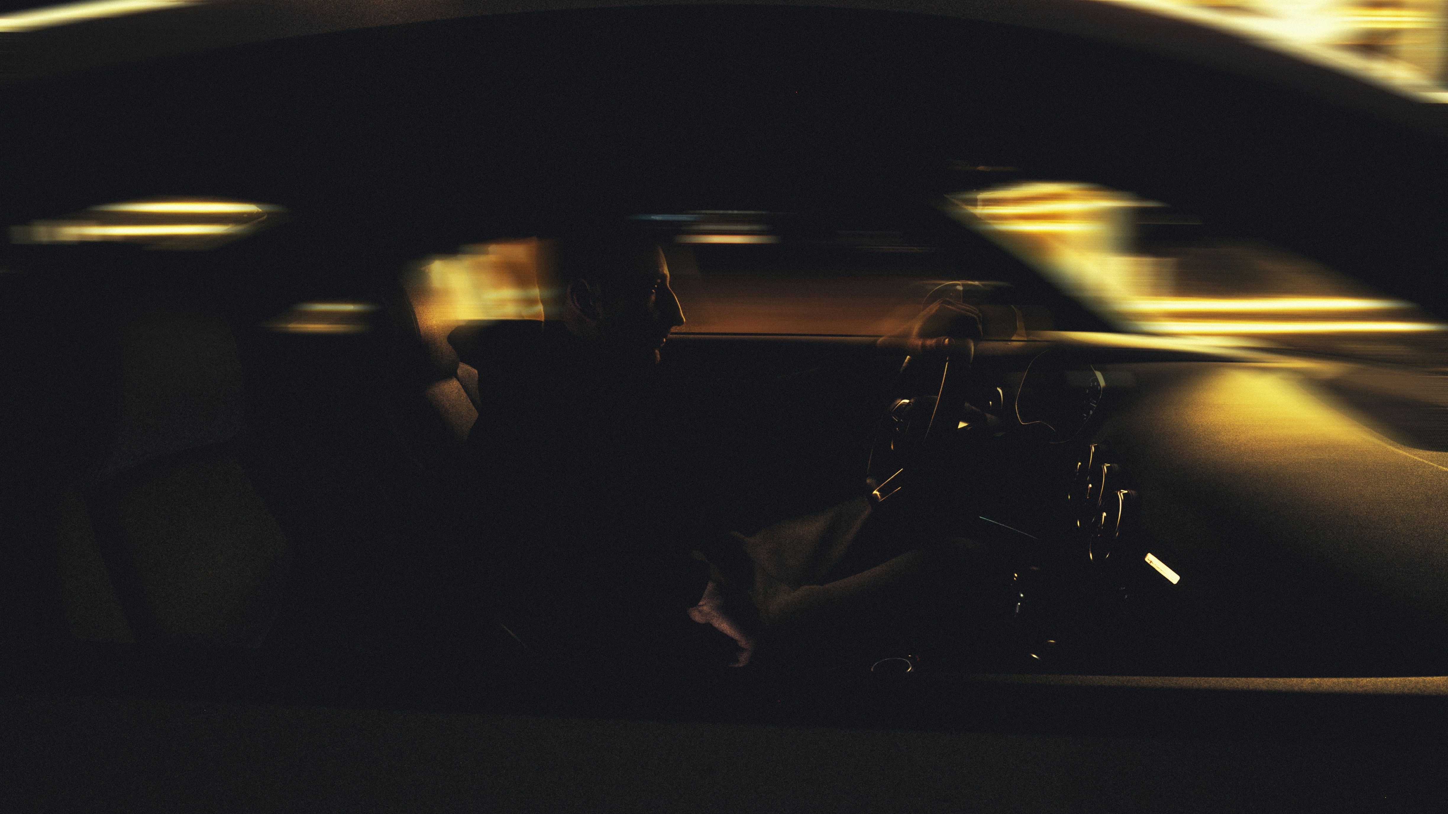 Image Silhouette of a driver gripping the steering wheel at night, showing the risks of a Labor Day weekend DUI in New Jersey
