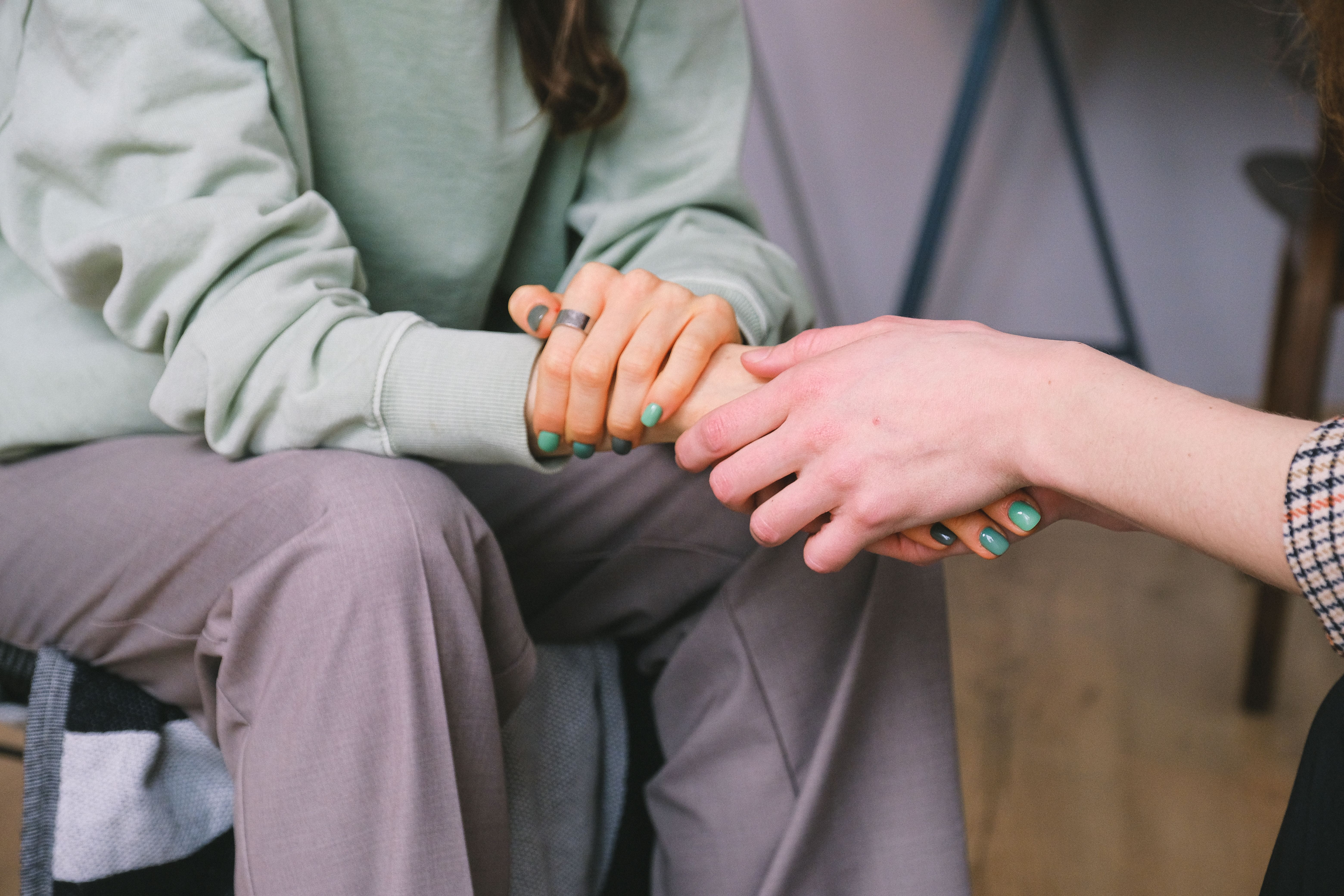 Supportive hand holding representing workplace protections under the Pregnant Workers Fairness Act.
