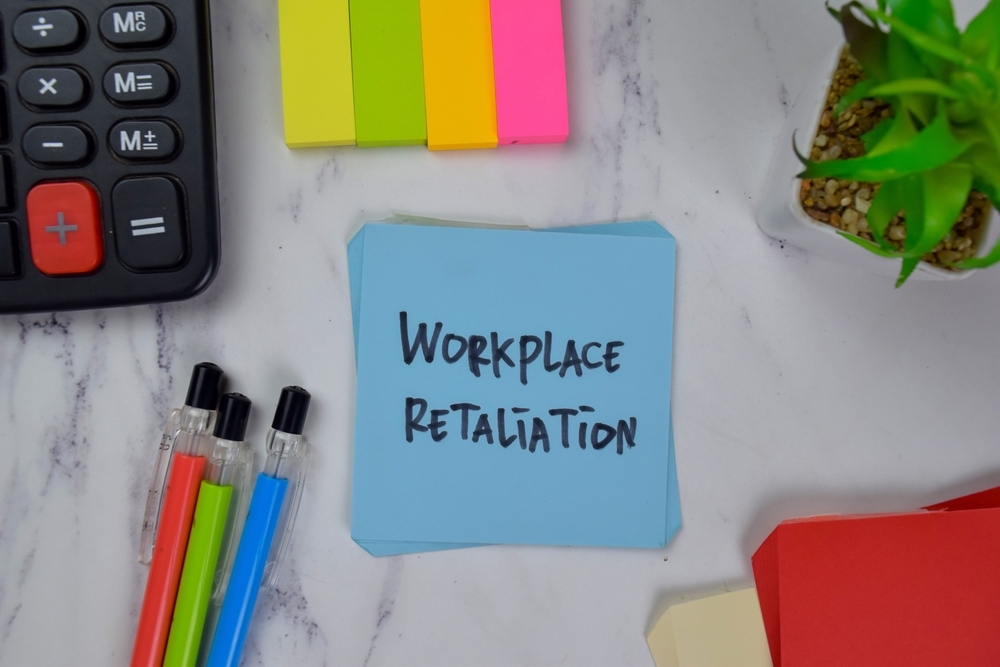 Image Sticky note reading workplace retaliation on a desk representing employee rights and retaliation protections under New Jersey employment law