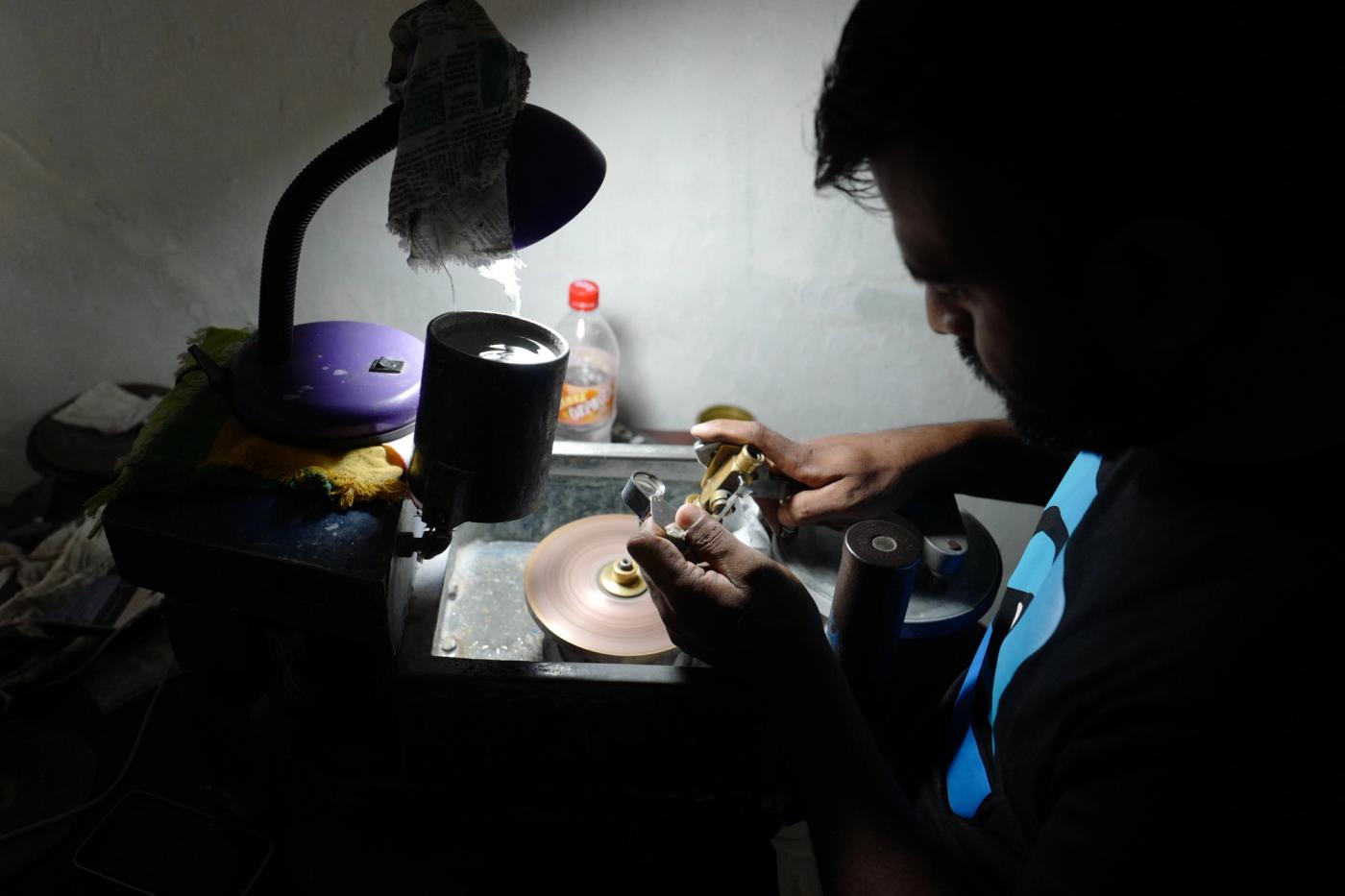 Skilled gemstone cutter polishing a natural gem