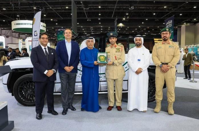 Dubai Police officers and Al-Futtaim Automotive Group representatives posing beside the Yangwang U8 patrol SUV at WETEX 2026