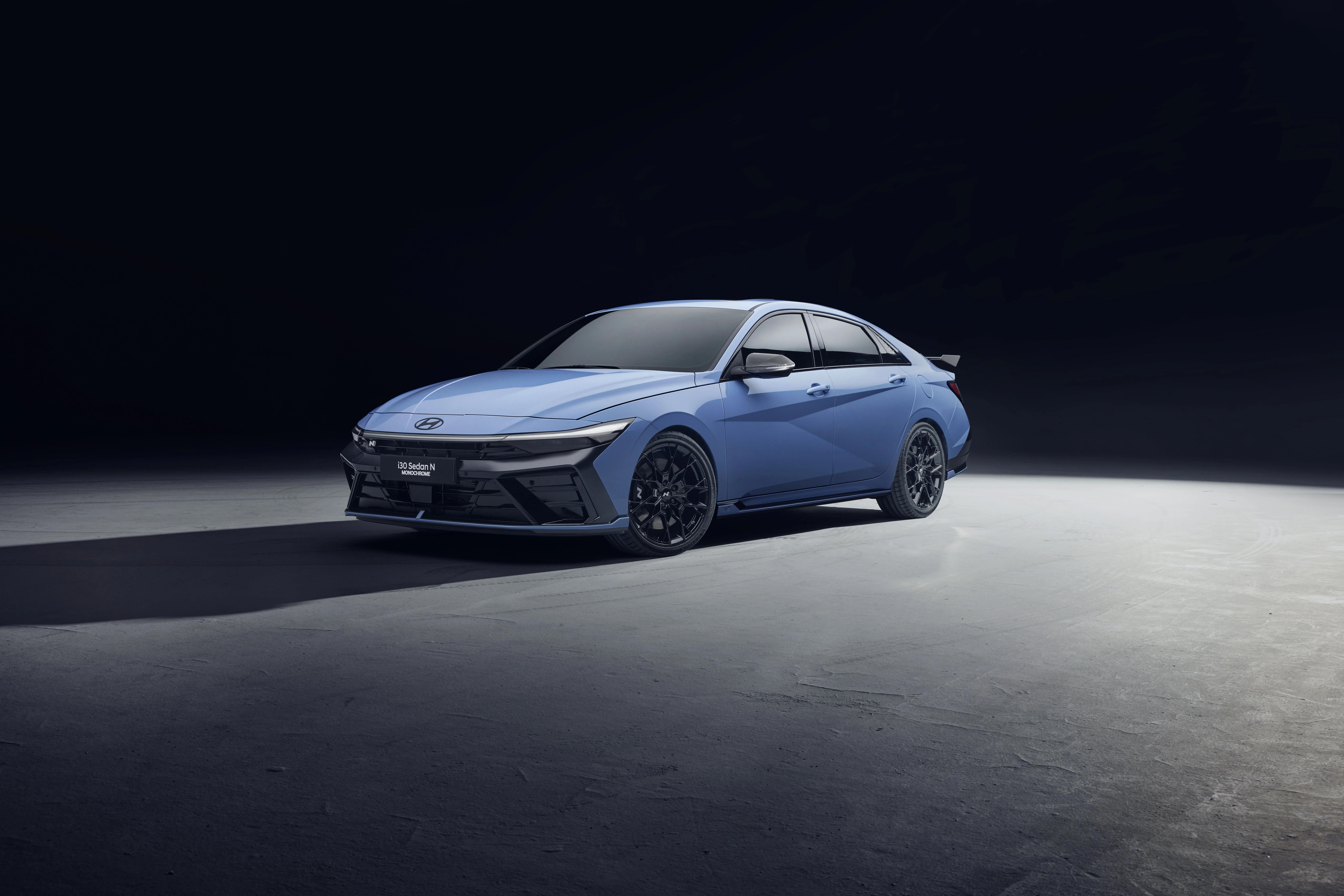 Three-quarter front view of the Hyundai i30 Sedan N MONOCHROME in Performance Blue