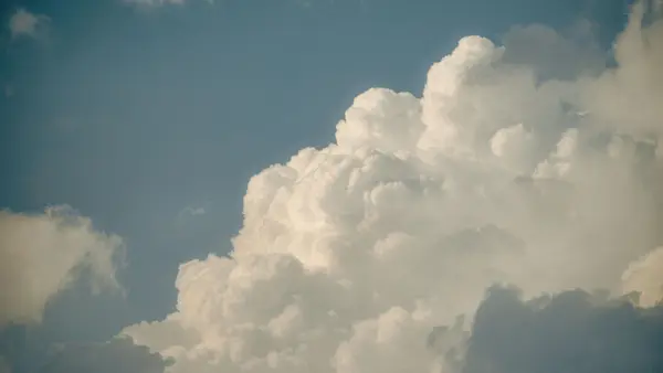 Cumulus clouds against a blue West Texas sky — the high desert we brought to Richardson