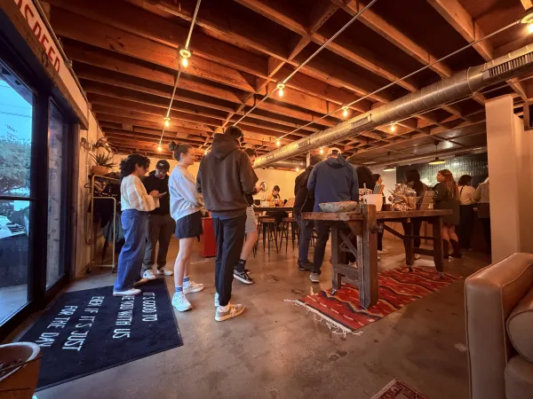 Moon Wolf Provisions at full capacity — the Wolfpack gathered on event night under string lights and exposed beams at 920 Custer Rd, Richardson TX