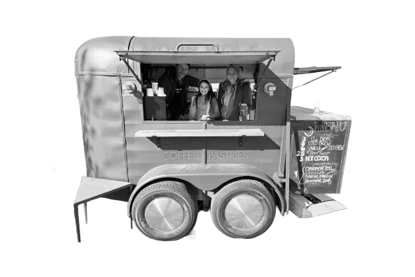 The Moon Wolf converted goat trailer with the crew serving from inside — coffee and pastries on wheels, before the storefront opened