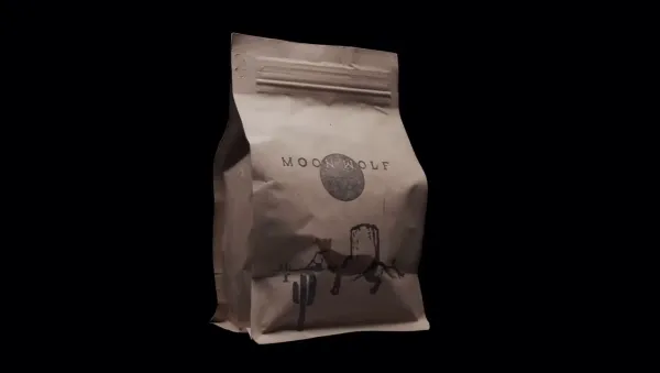 A Moon Wolf kraft coffee bag against a dark backdrop — the cowboy-and-cactus mark above MOON WOLF, where every single origin lands before it hits the bar