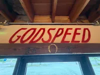 The hand-painted GODSPEED sign above the front door of Moon Wolf Provisions in Richardson, Texas — minutes from the University of Texas at Dallas