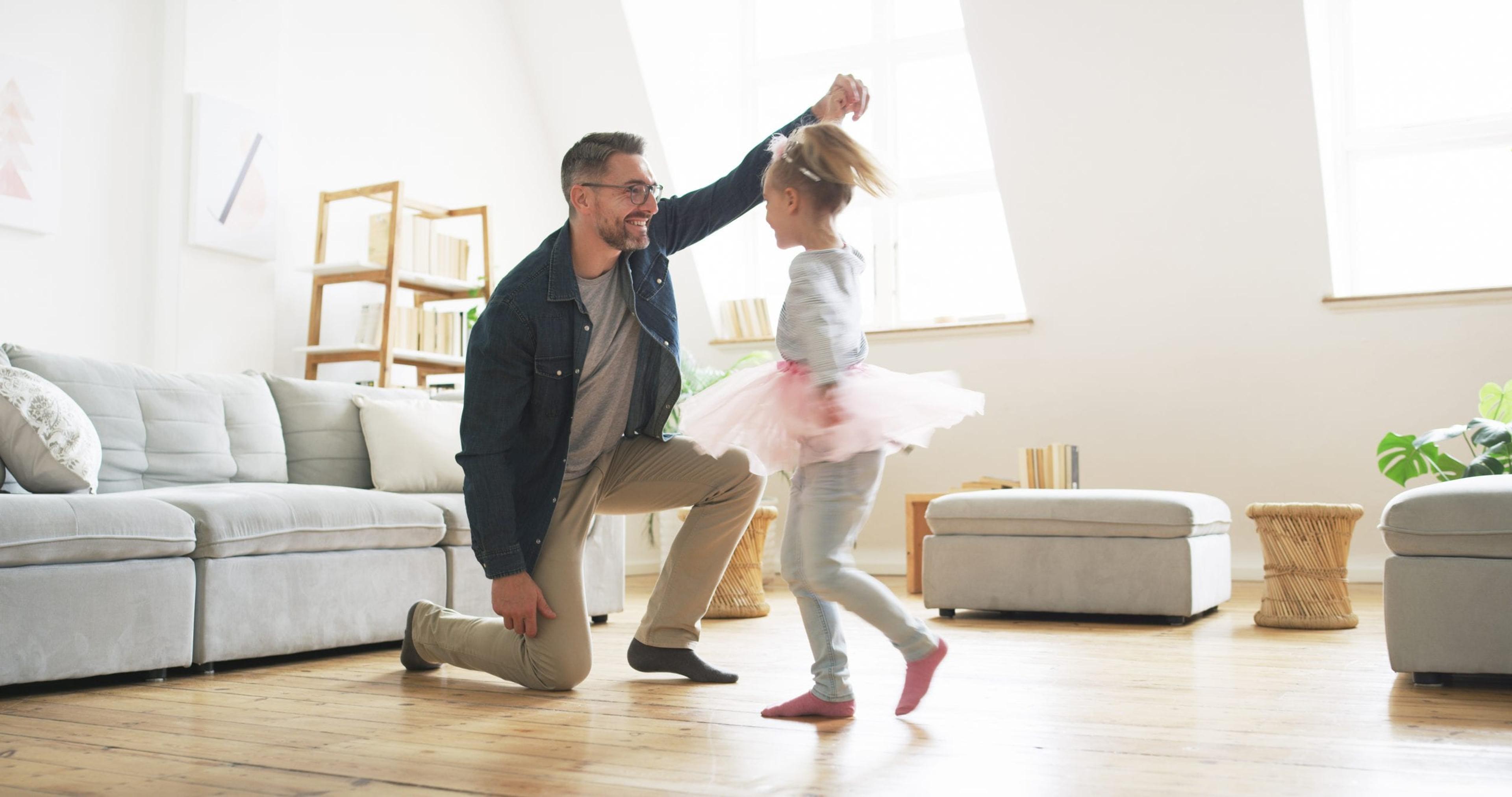 Shot of a father dancing with his little daughter at home