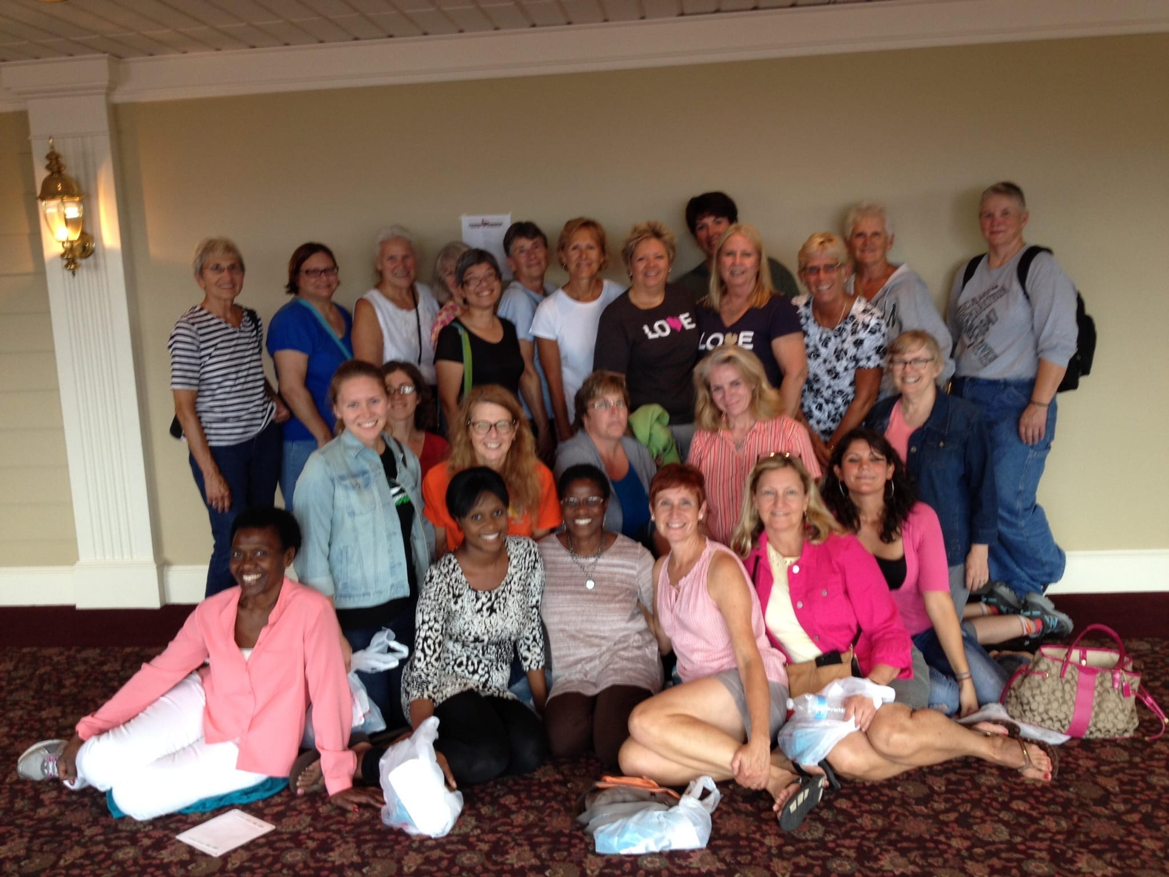 Sally Purdy with some of her running friends. She is seated third from the right in a pink tank top. 