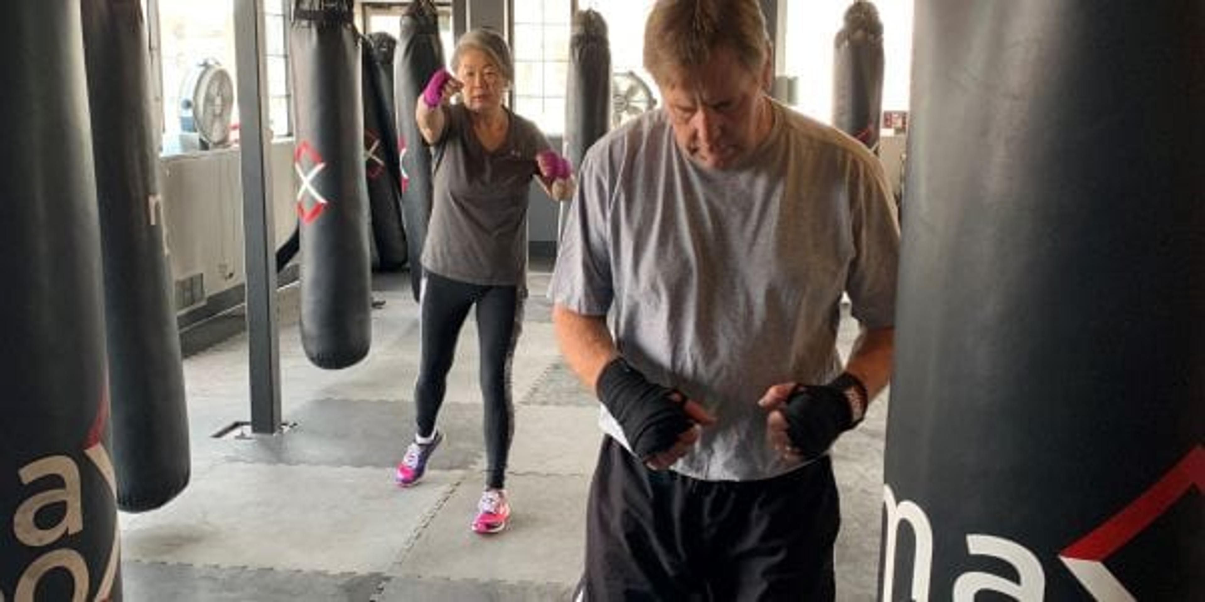 Two heavy weight bags with two boxing participants practicing movement between them