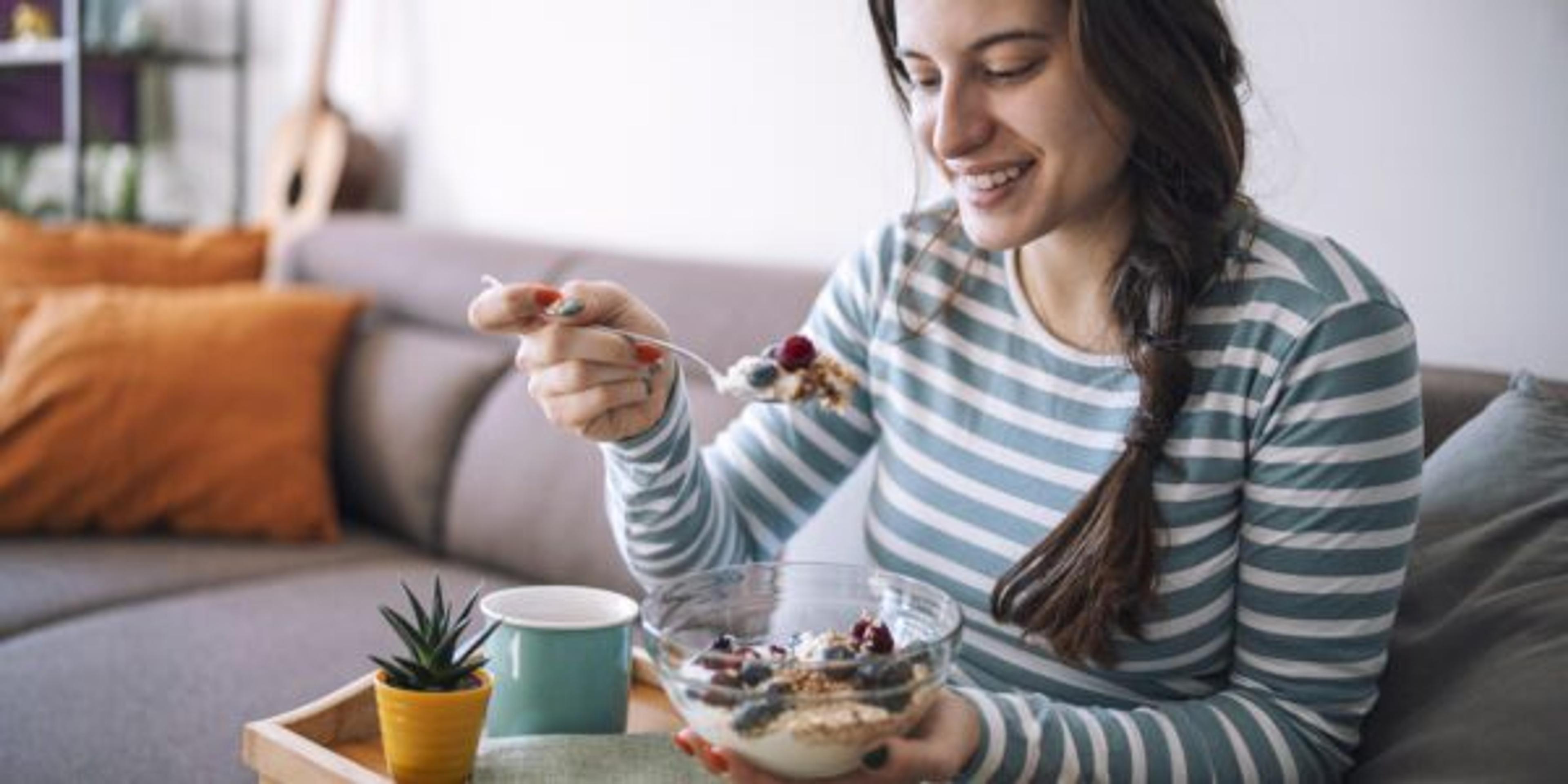 Smiling Woman Having Breakfast In The Morning At Home