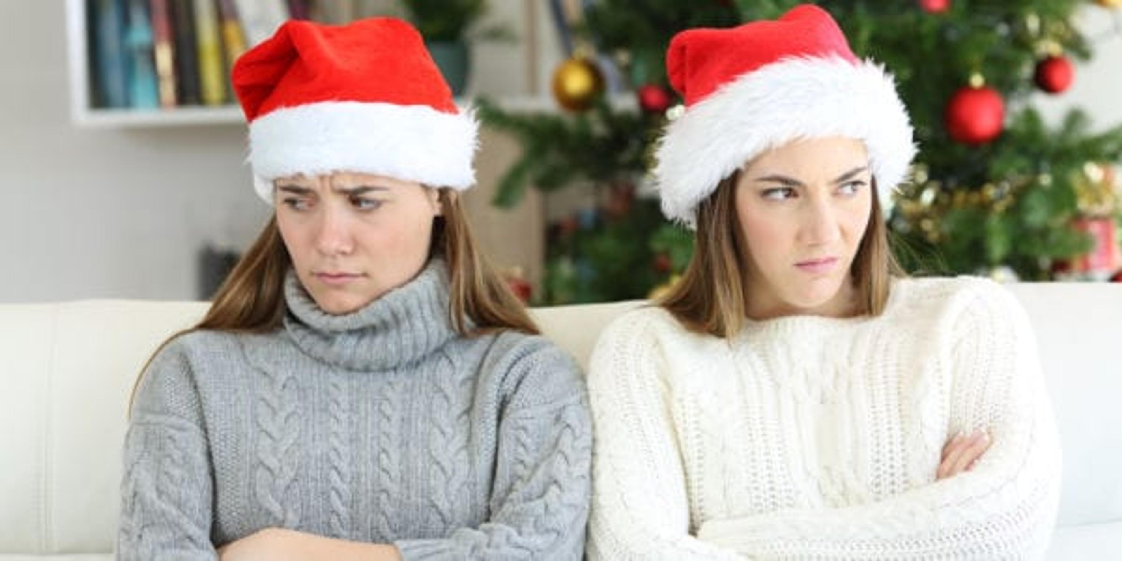 Angry sisters in front of the Christmas tree