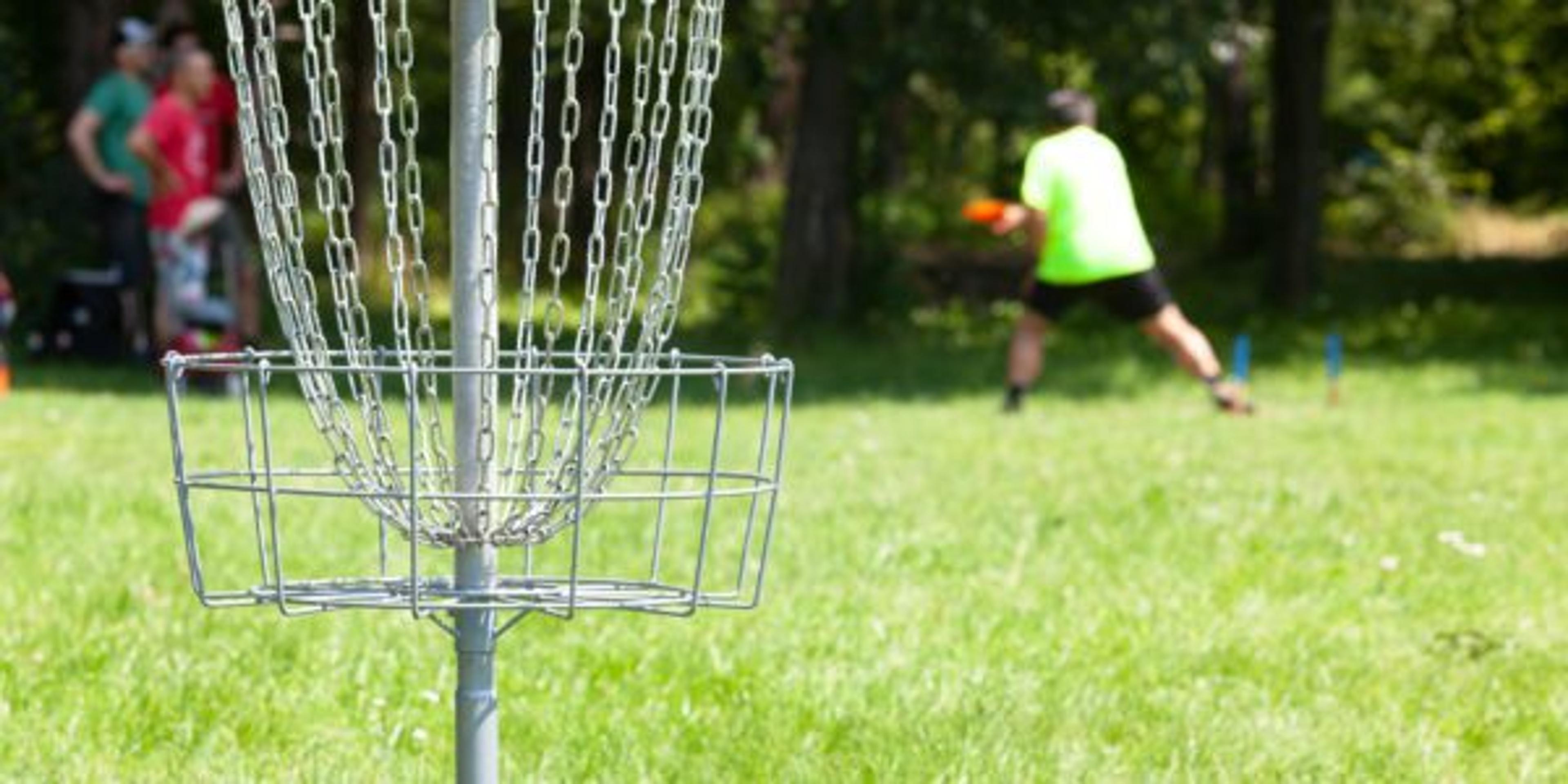 Man playing flying disc sport game in the city park