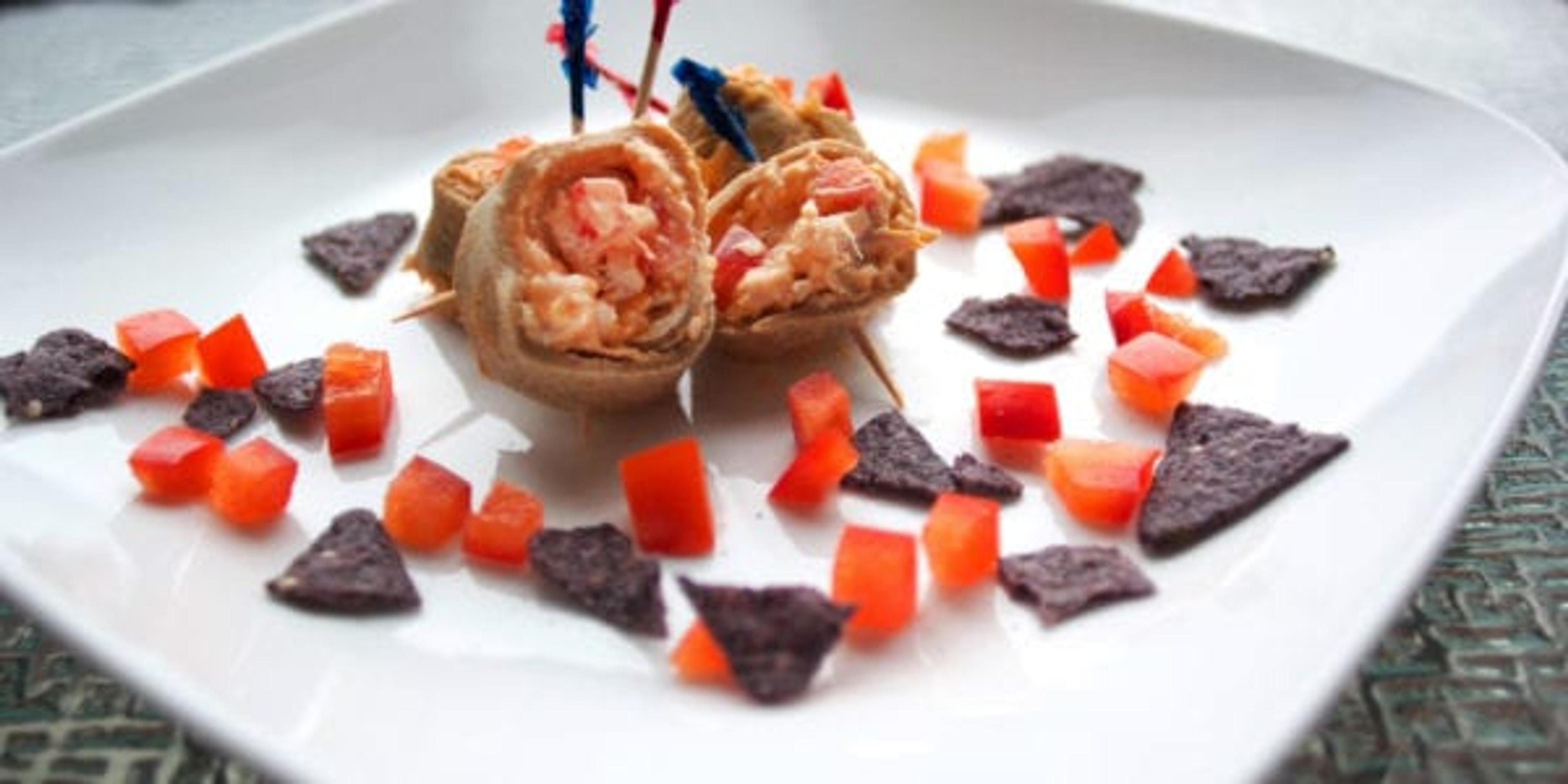 Tortilla pinwheels and tortilla chips on a plate.