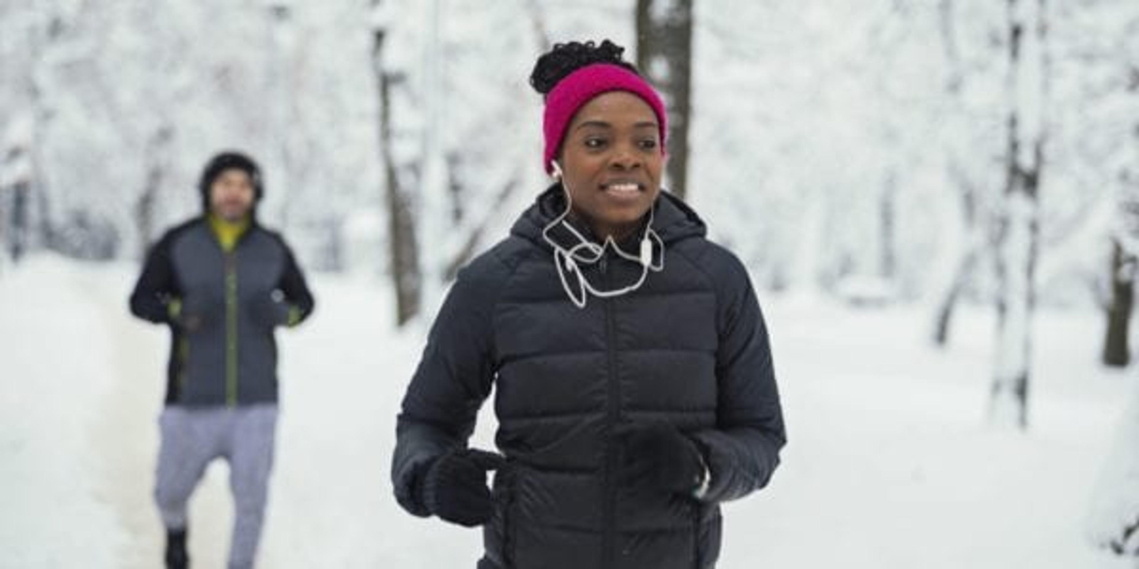 Woman running through the snow