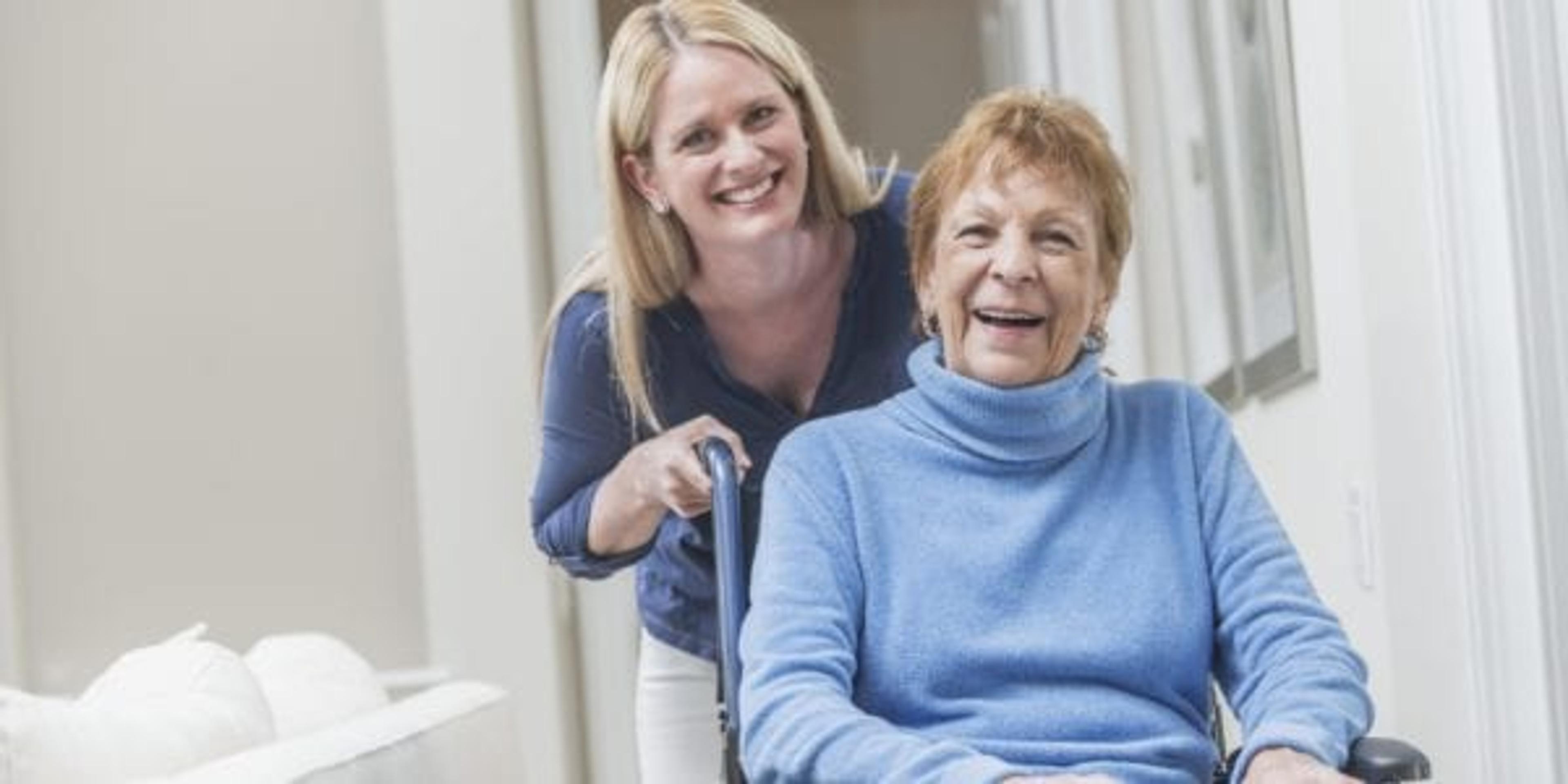 Woman pushing her mom in a wheelchair