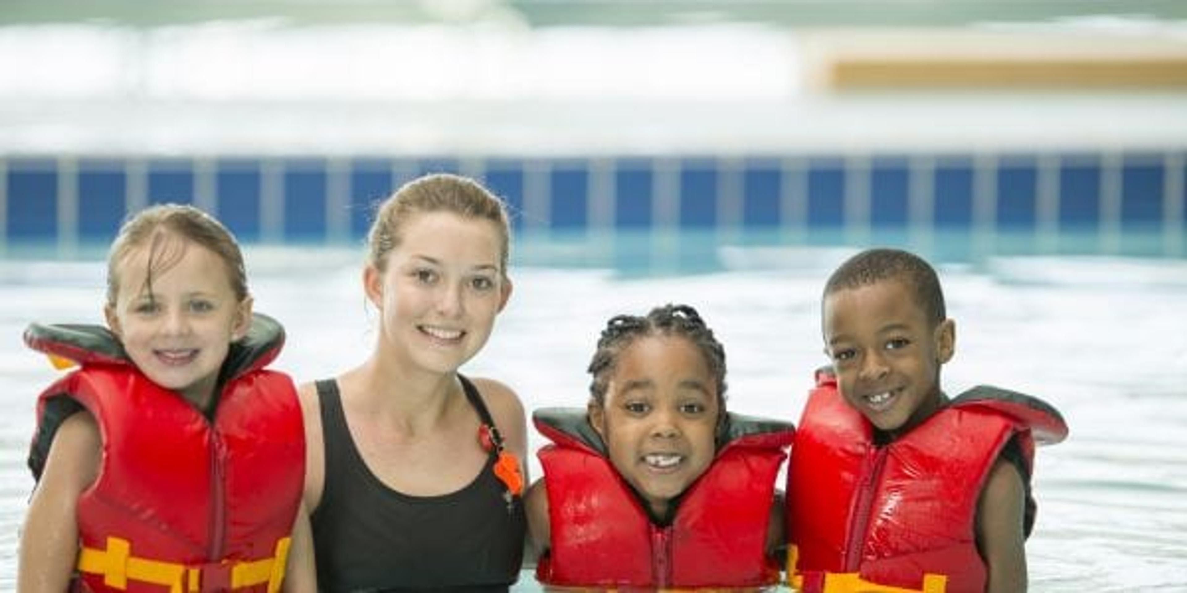 schoolage children taking swim lessons