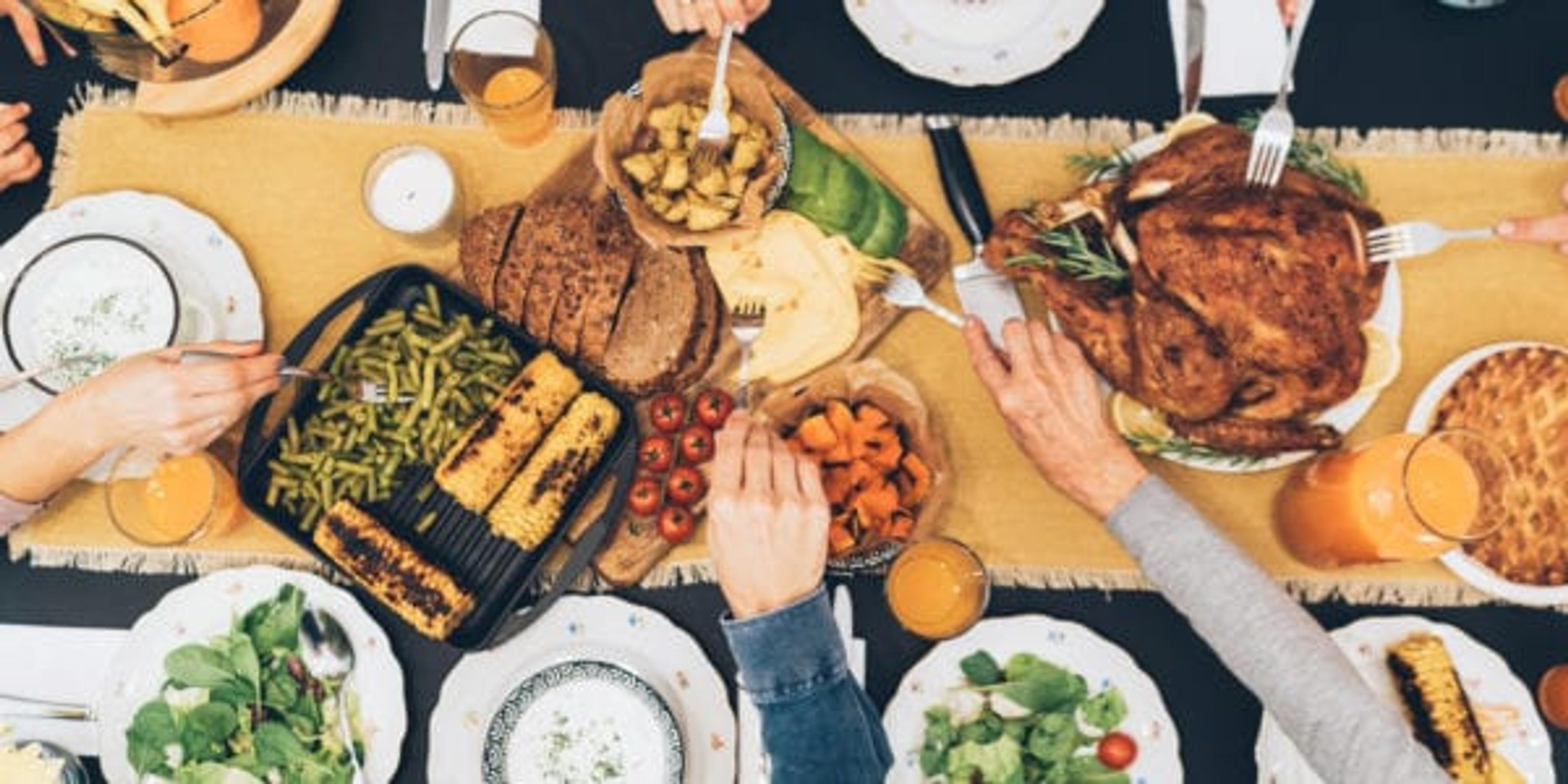 Overhead view of big family eating from table during Christmas dinner