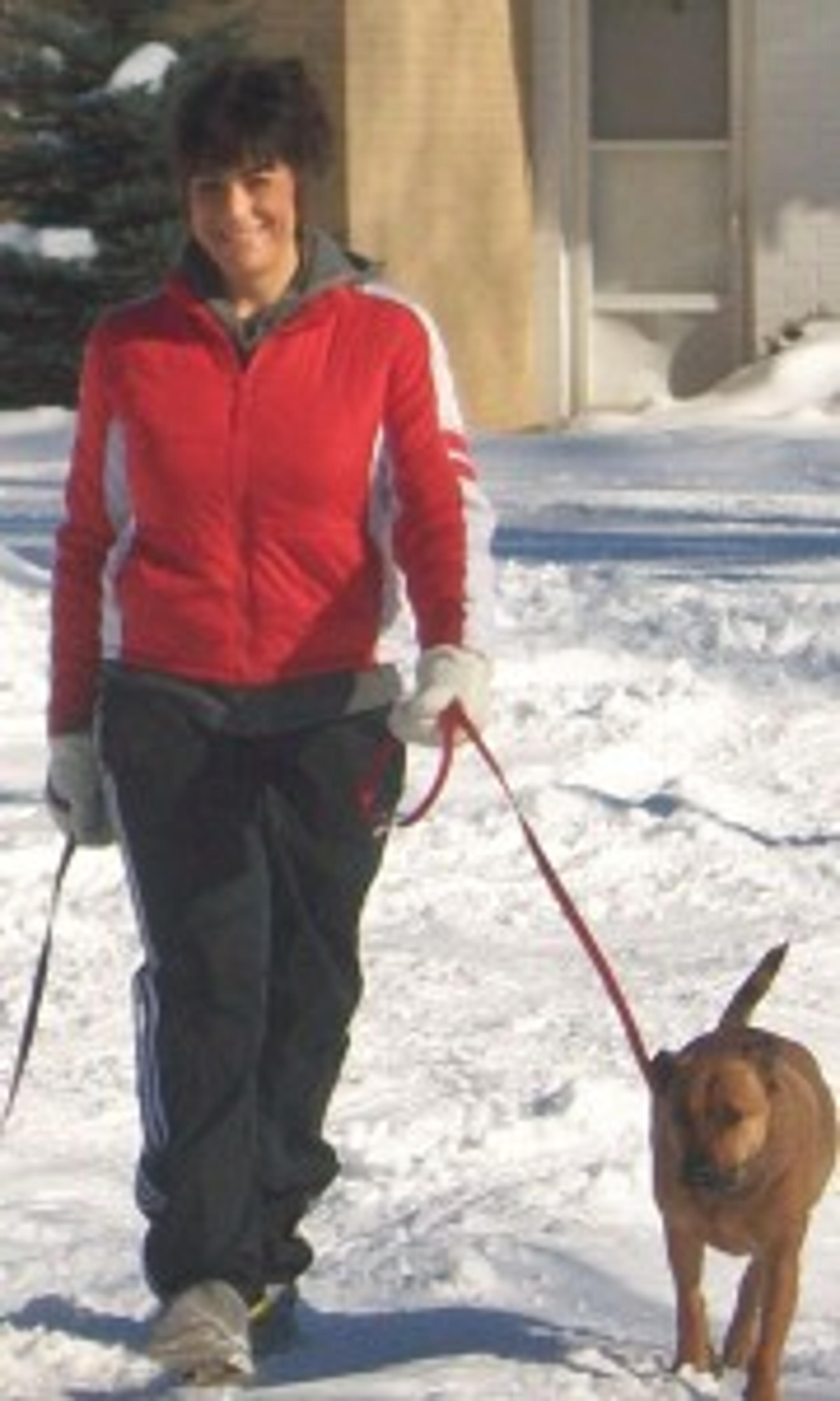 Jodi Davis walks with her dog