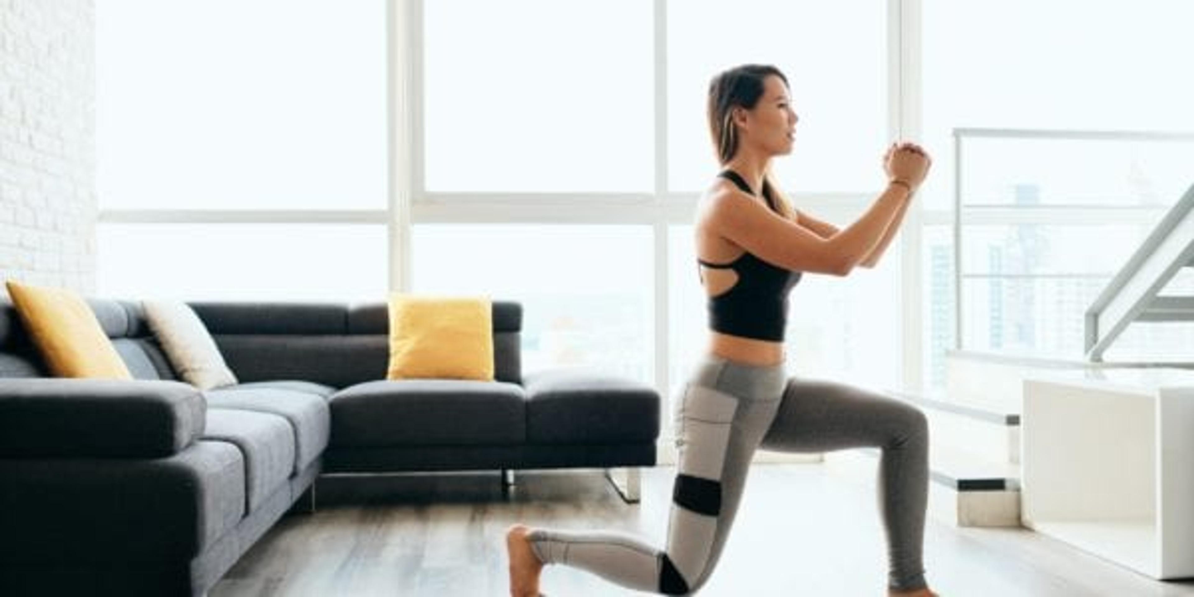 Woman doing lunges in her family room