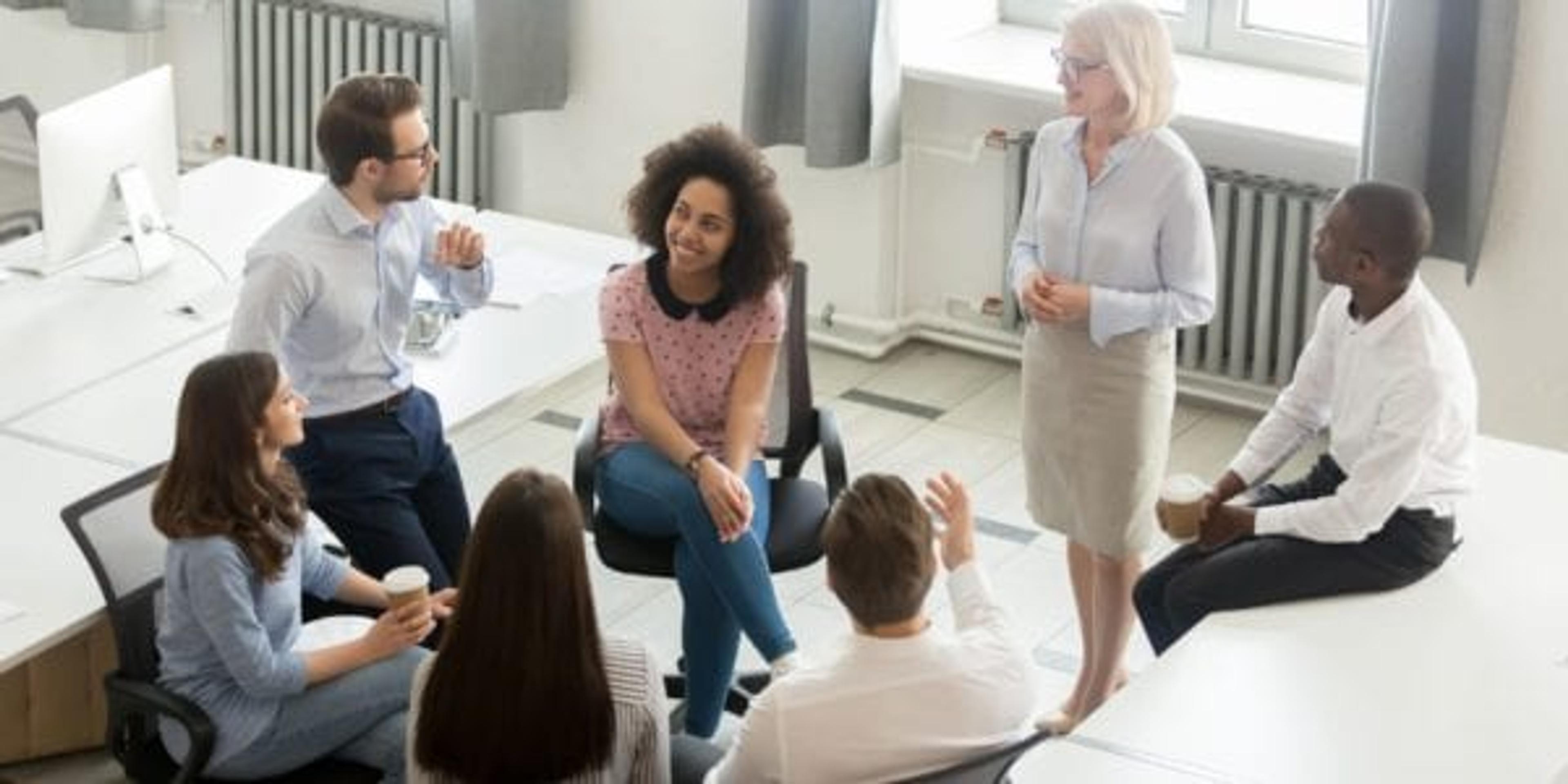 Business people group discussing work plan with coach at meeting