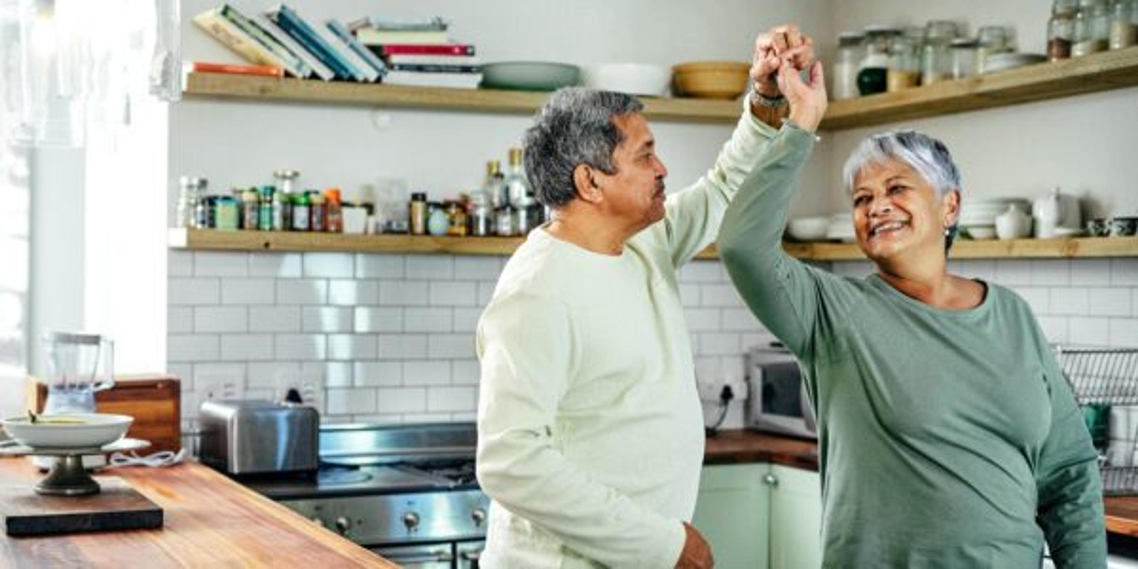 Shot of a happy senior couple dancing in their kitchen at home