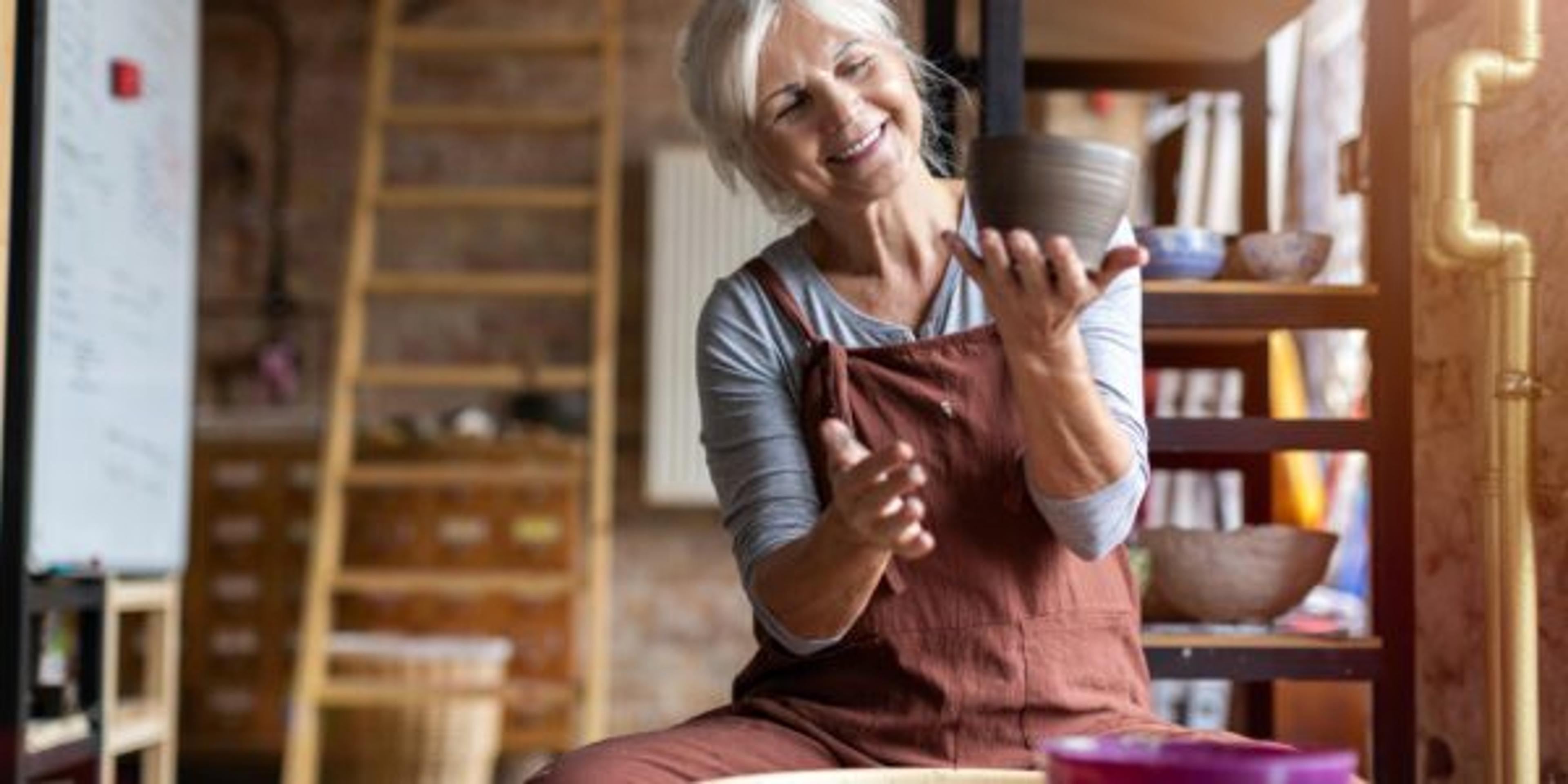 A woman enjoys a pottery project.