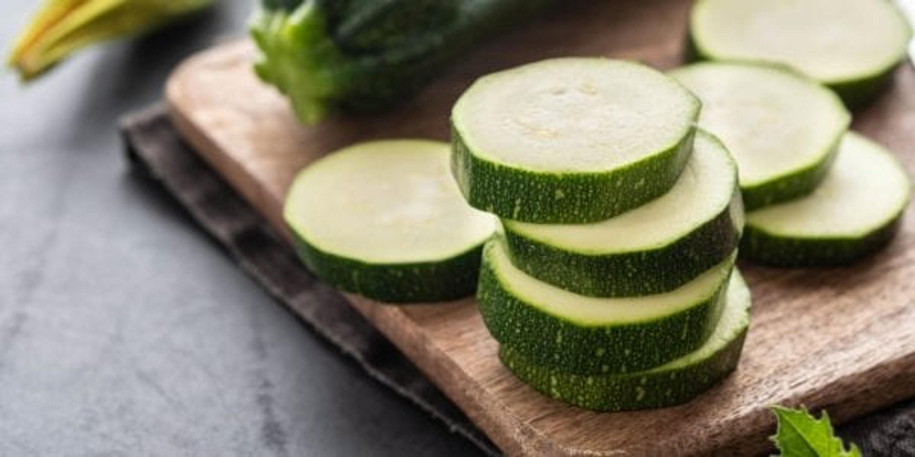 Fresh zucchini on wooden table close up.