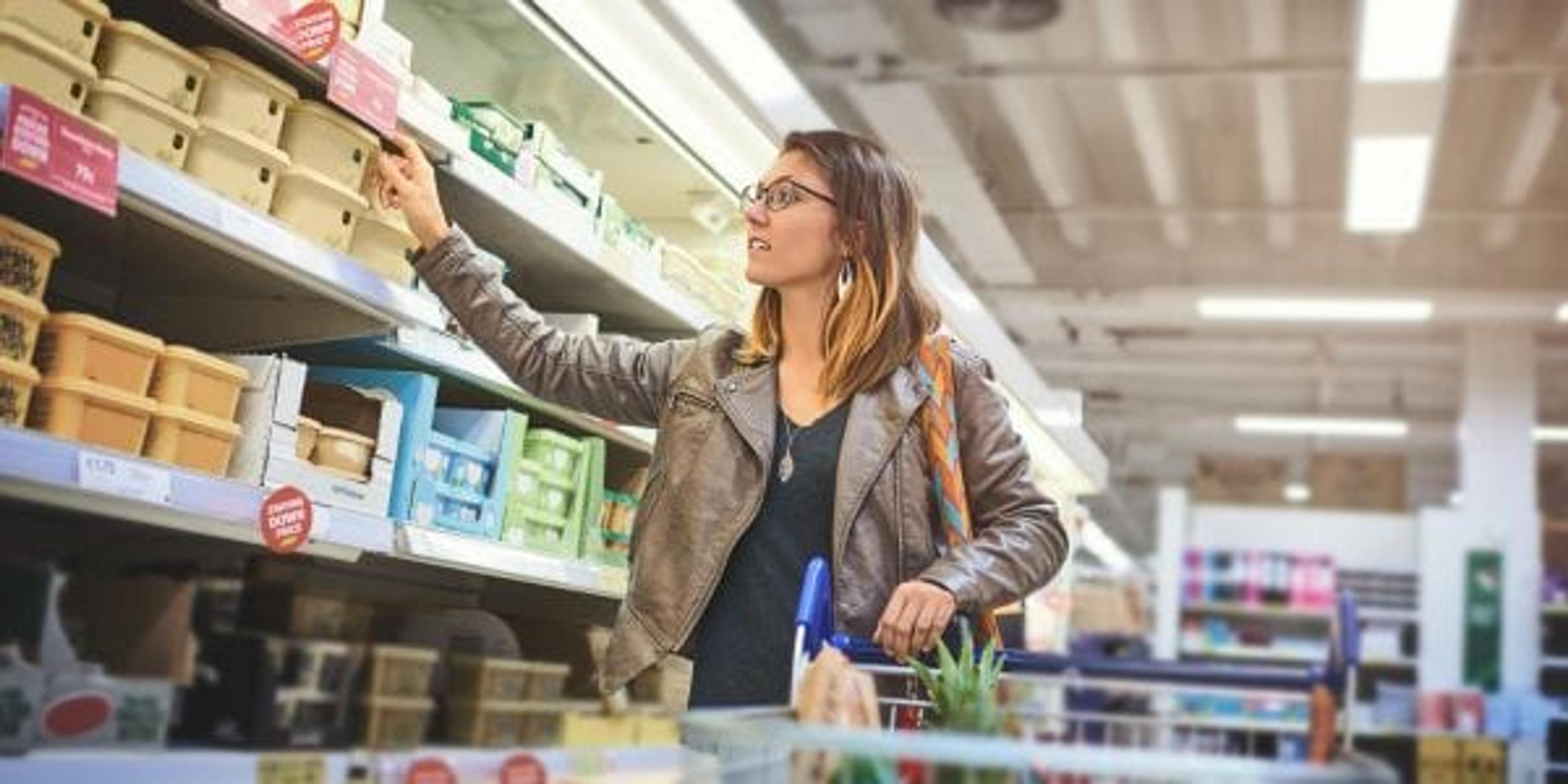 Shot of a young woman shopping at a grocery store.