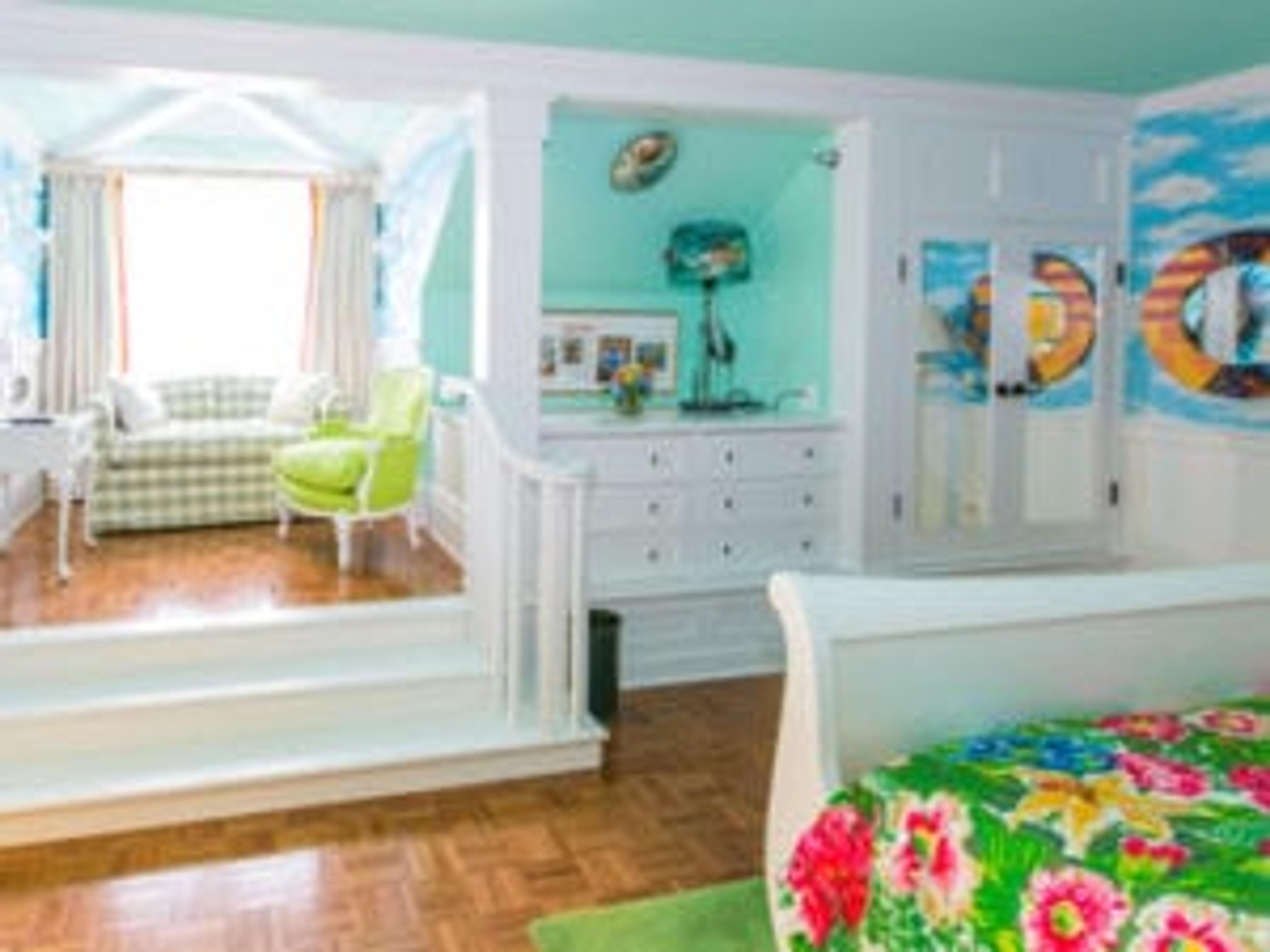 a room painted bright blue with a big sunny window