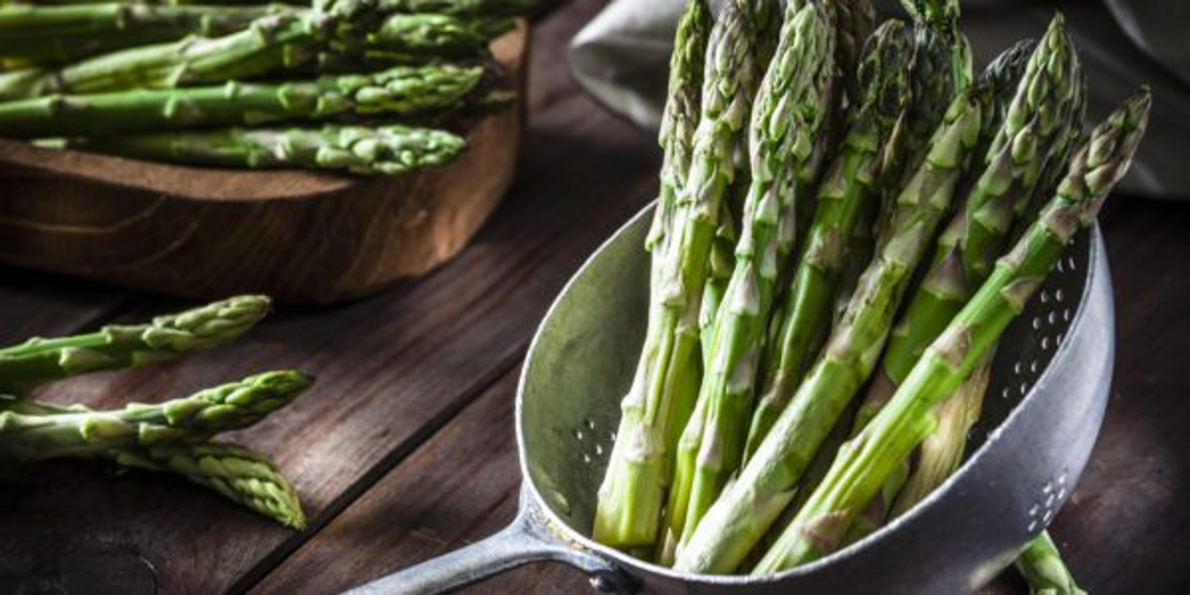 Fresh asparagus in an old metal colander