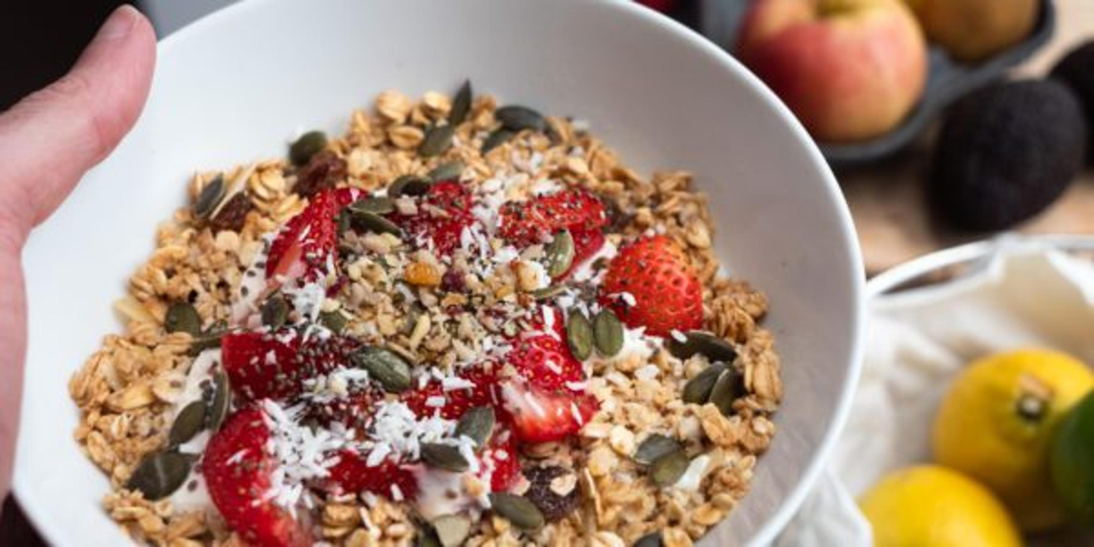 Bowl of freshly made granola with fruit and nuts