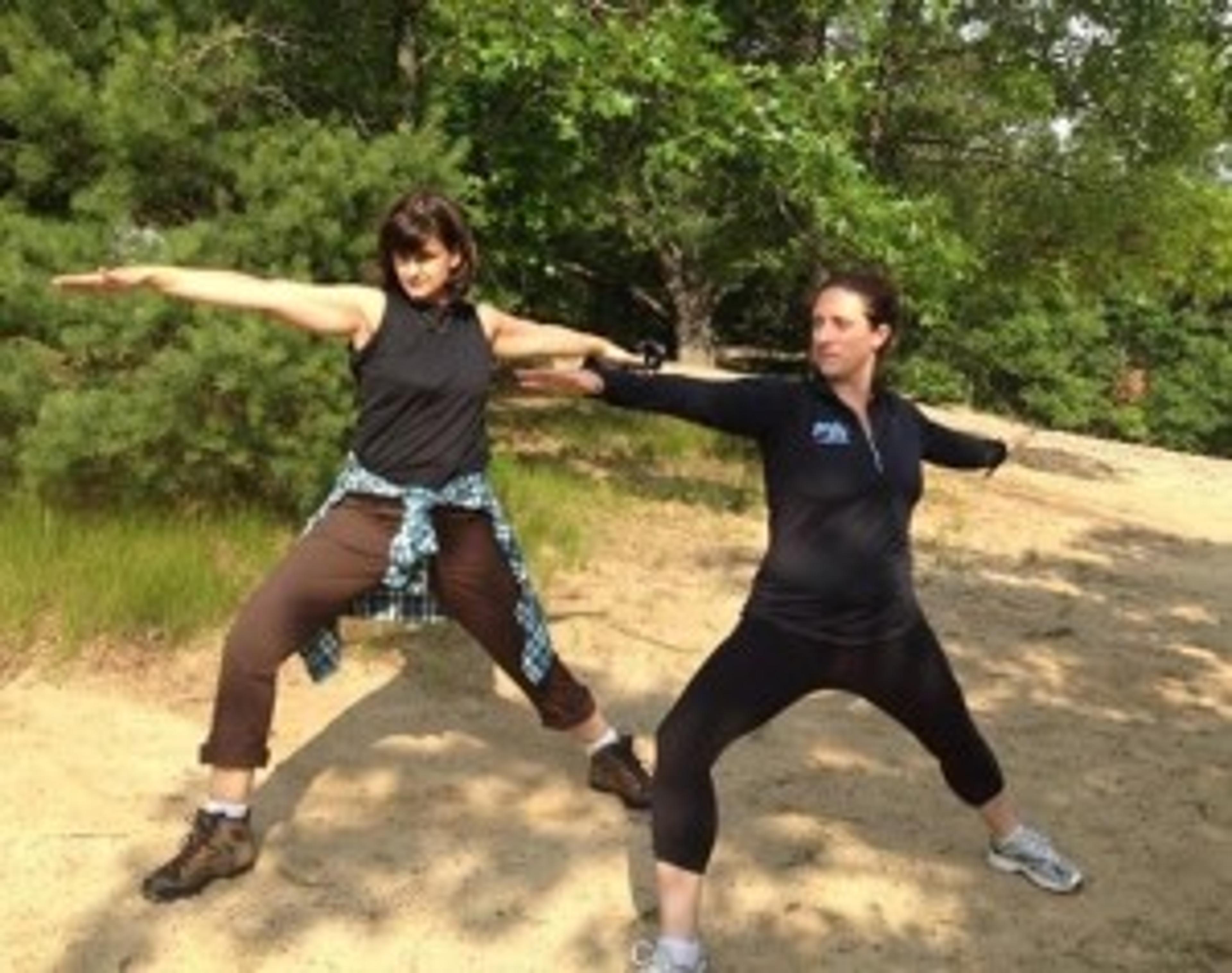 Jill Hinton, left, practices yoga with Elizabeth Sanders, owner of Yoga Heat. The pair were photographed doing potential Outdoor Book Club activities to submit along with Hinton's application to appear on ABC's Shark Tank.