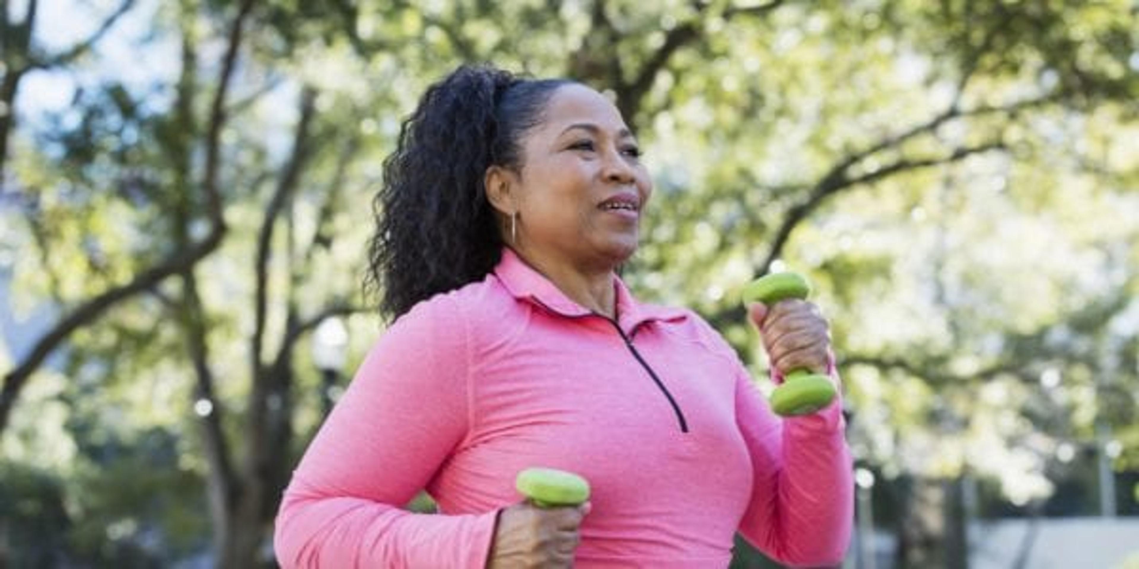 Woman power walking with hand weights