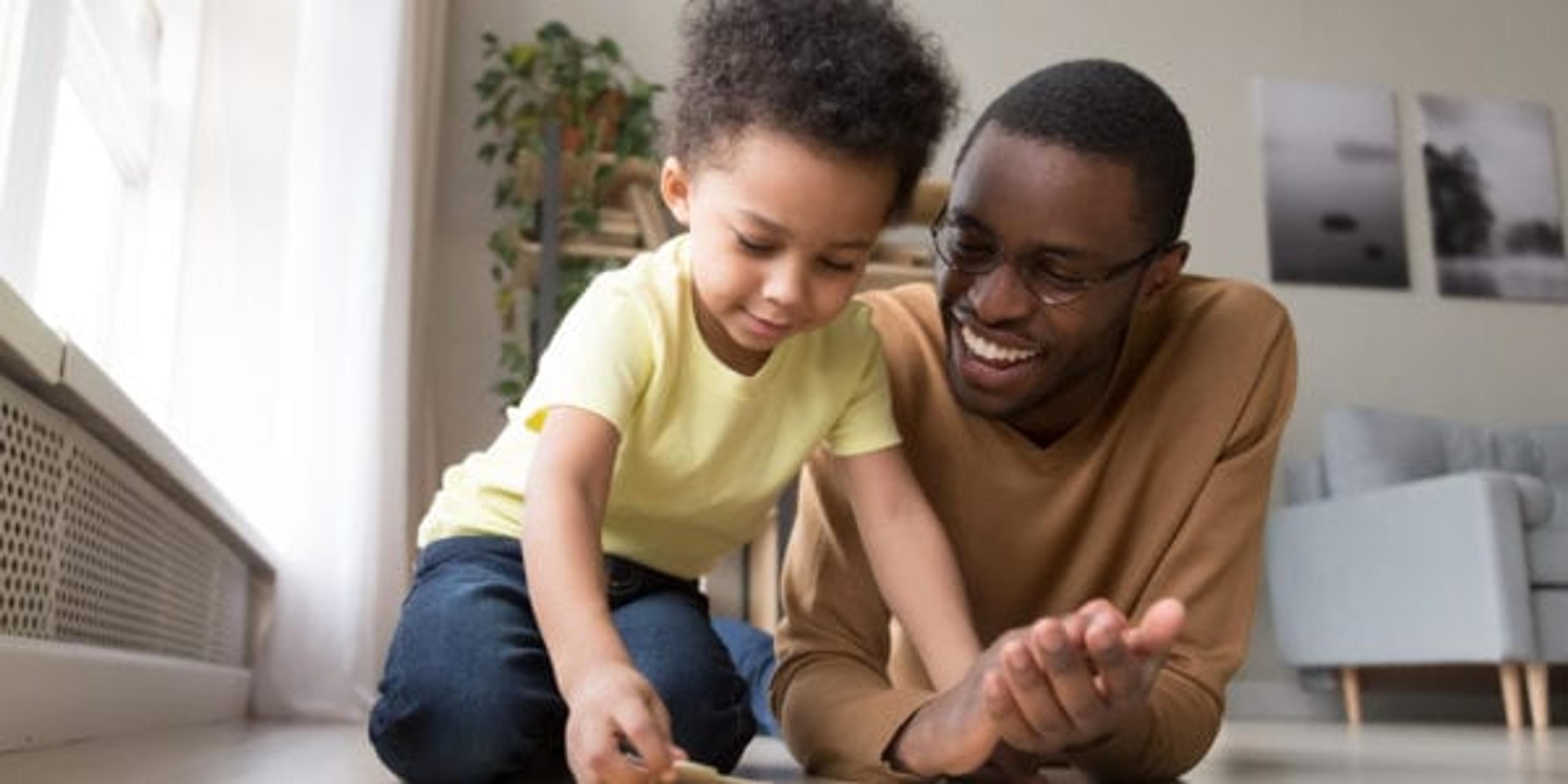 Dad helping his little boy put a puzzle together