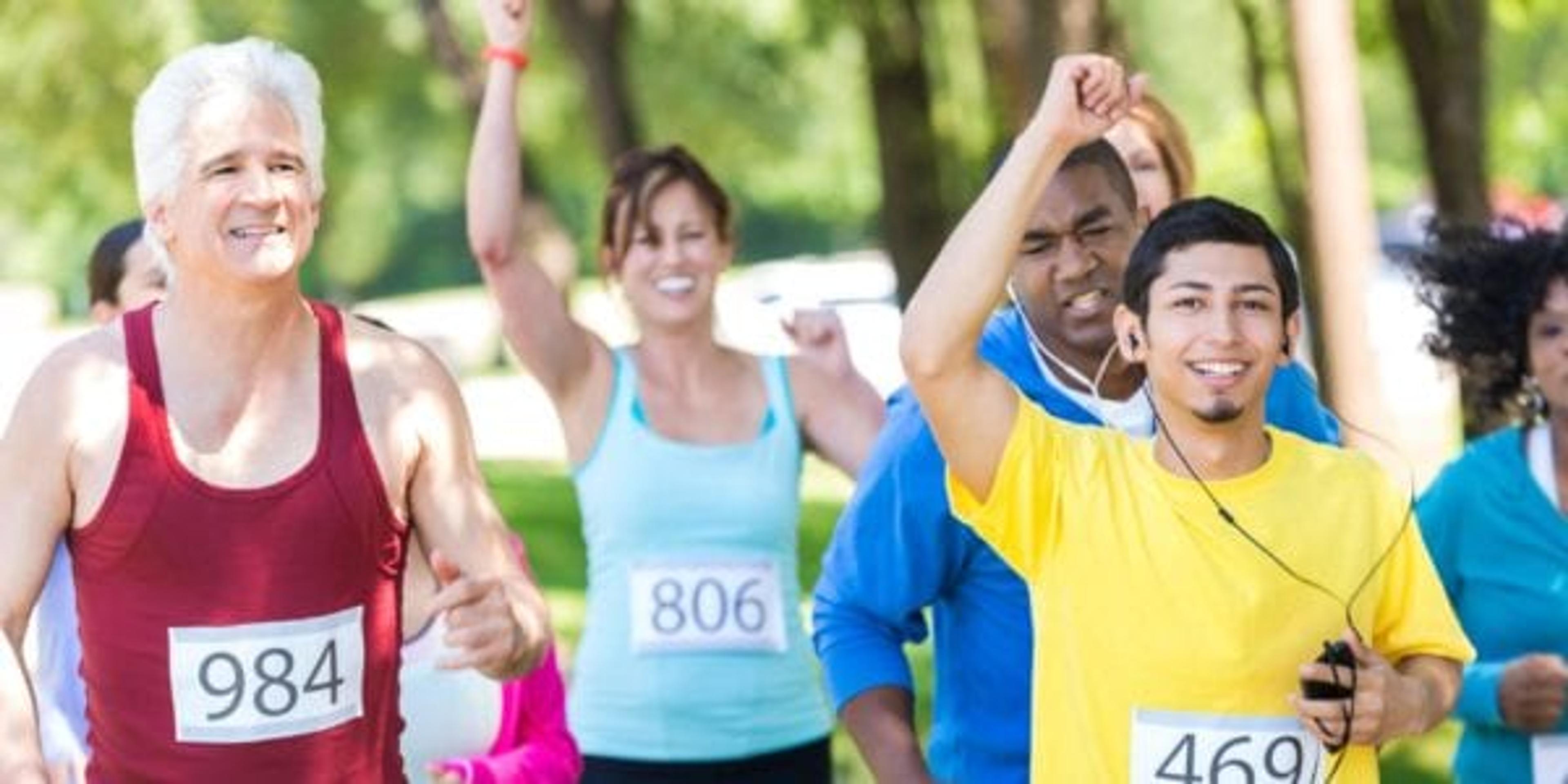 group of people crossing finish line of charity walk