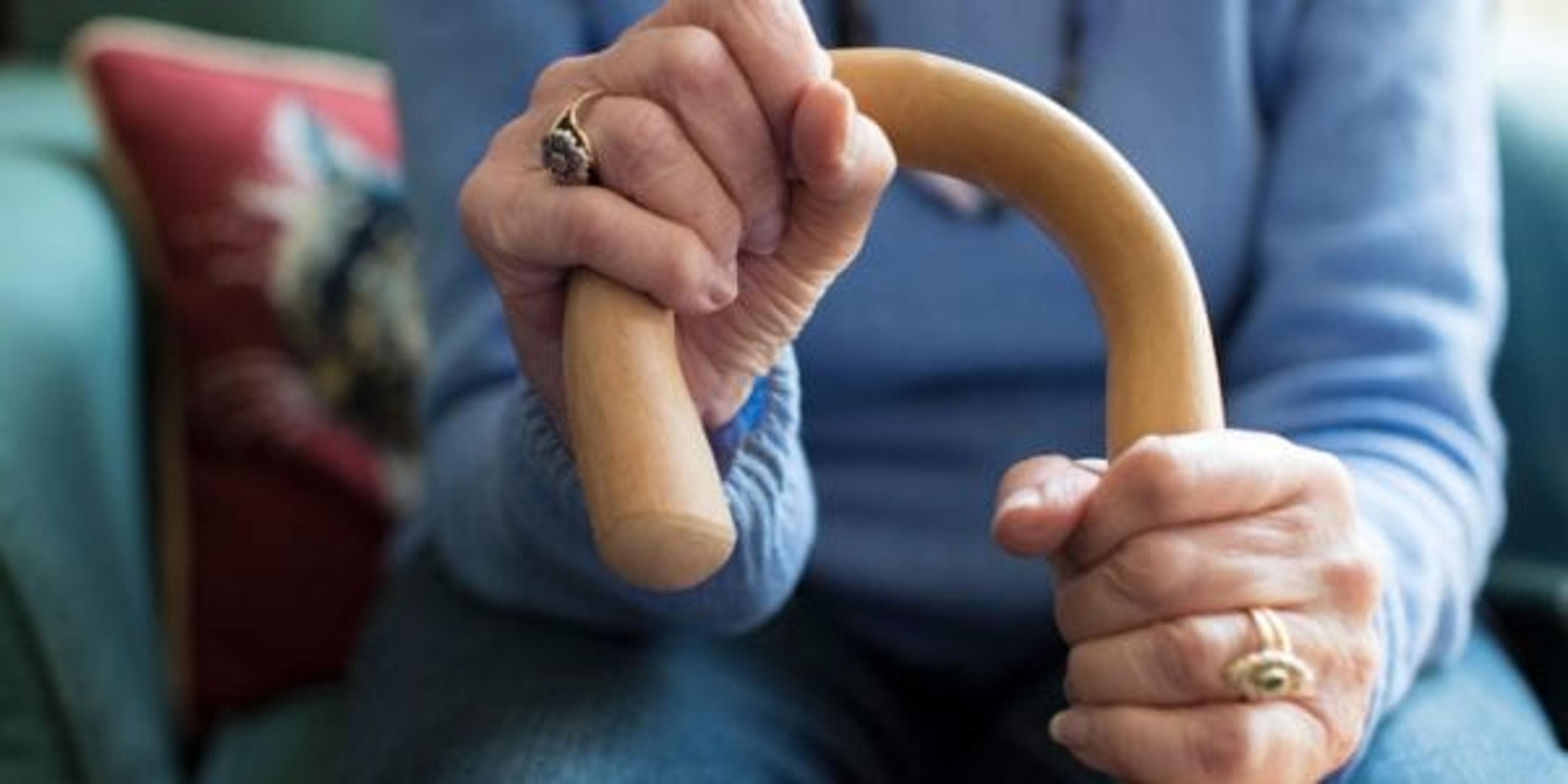 Older woman holding a cane