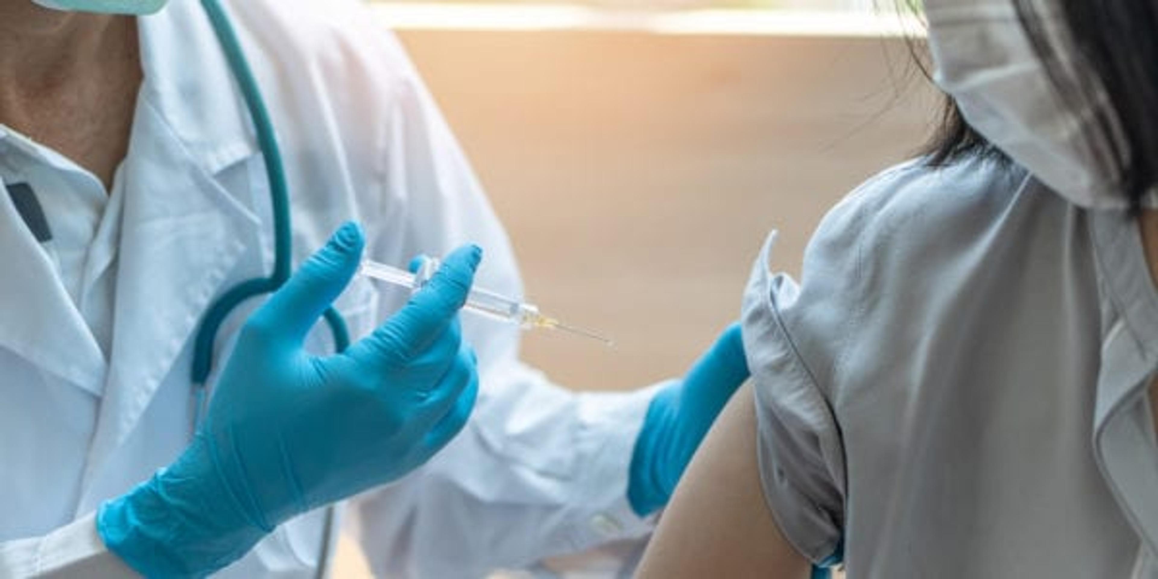 Young woman getting a flu shot