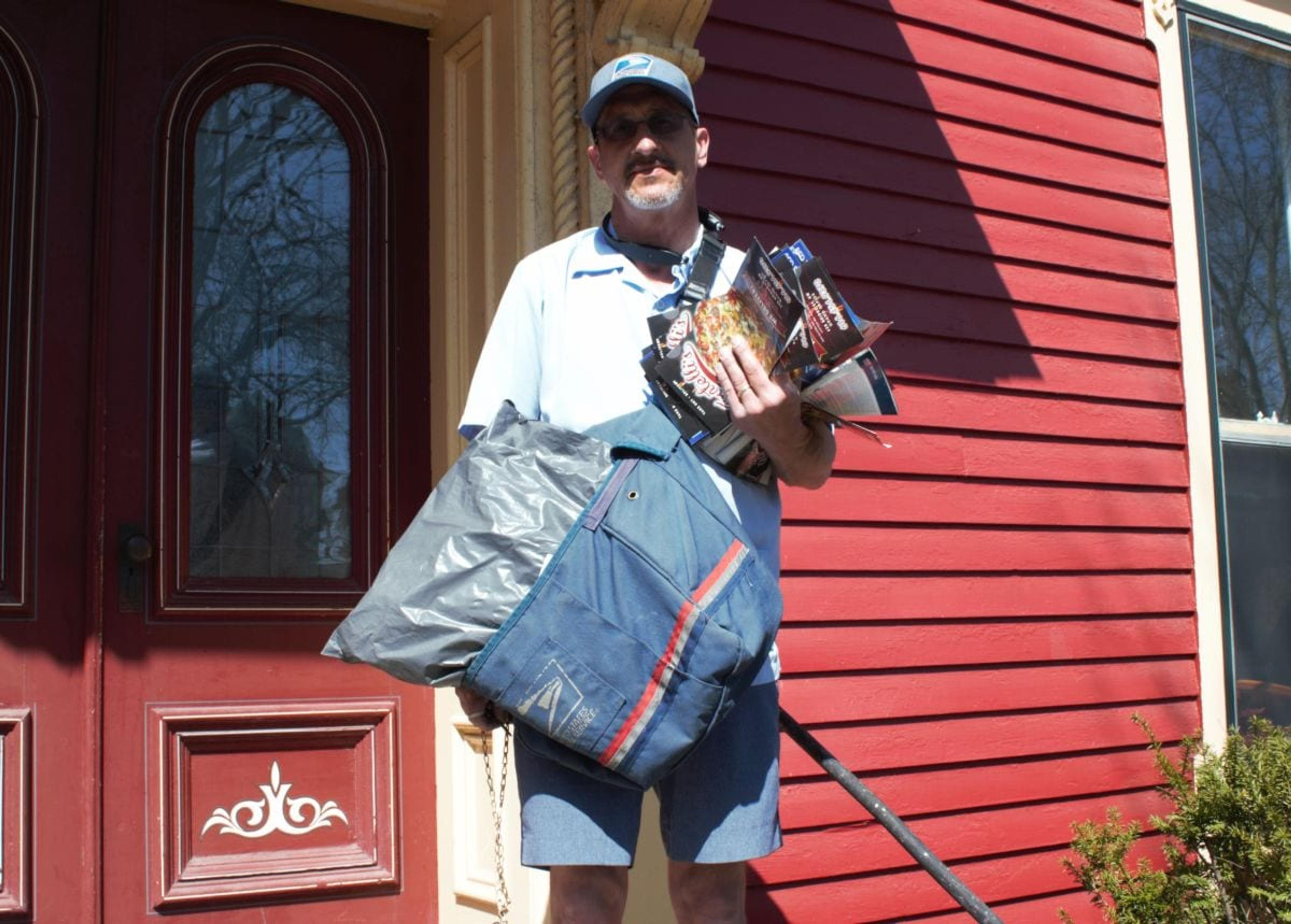 Ron Kammers delivering mail on his Heritage Hill route.