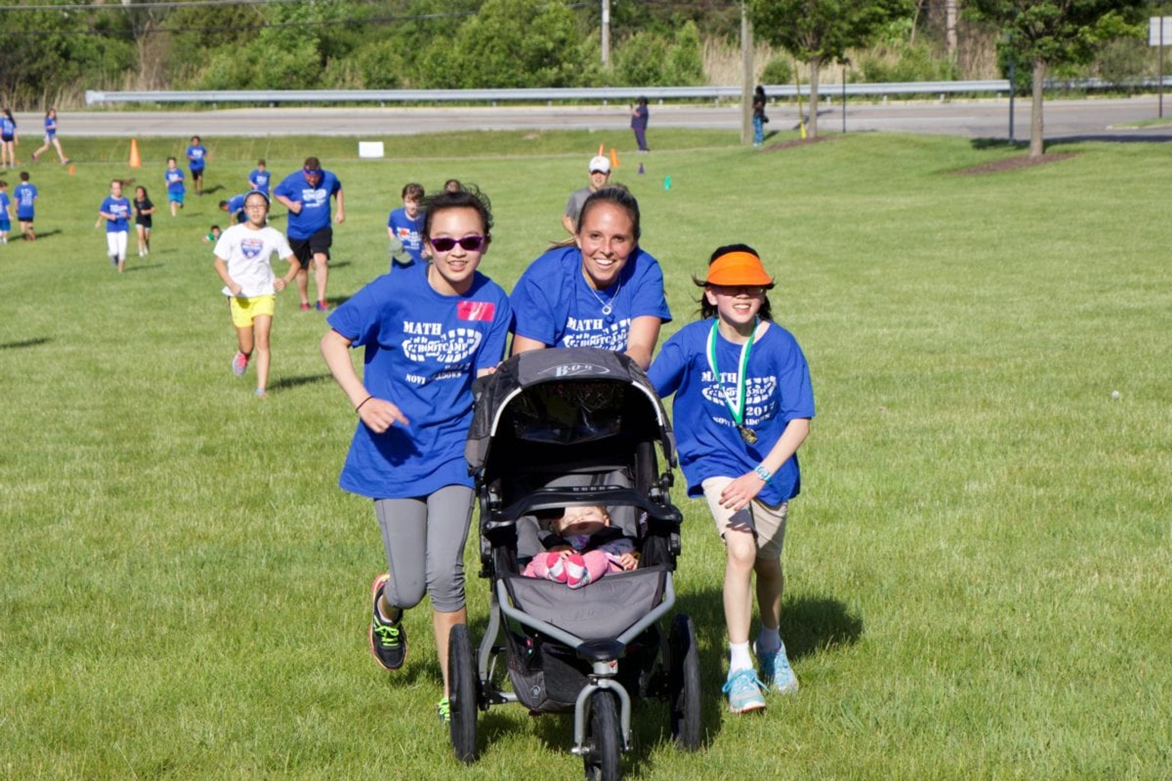 Teacher pushing stroller with students