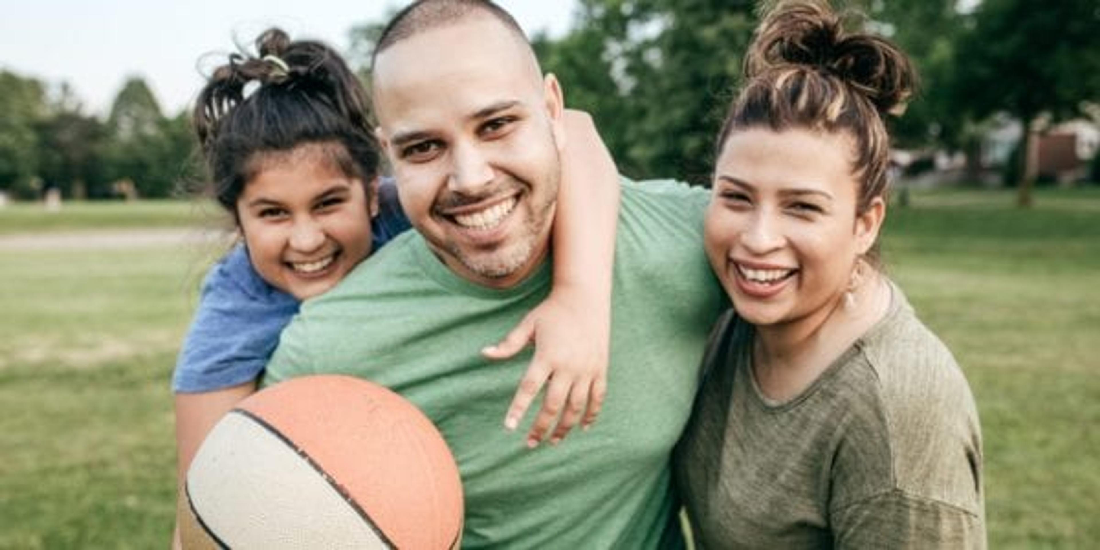 Man playing basketball with his family