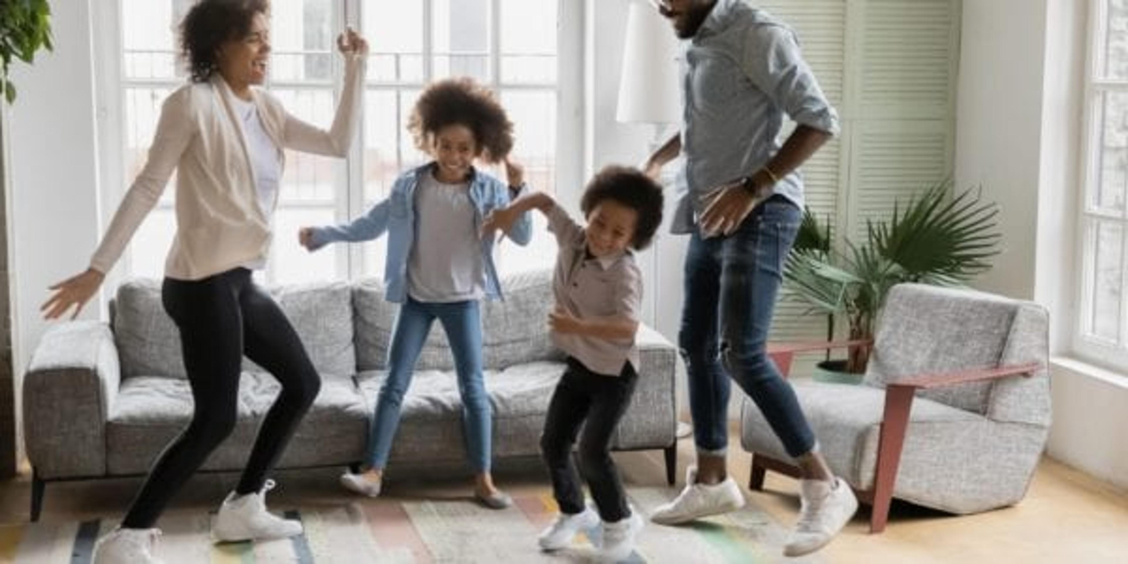 Active family dancing in the living room