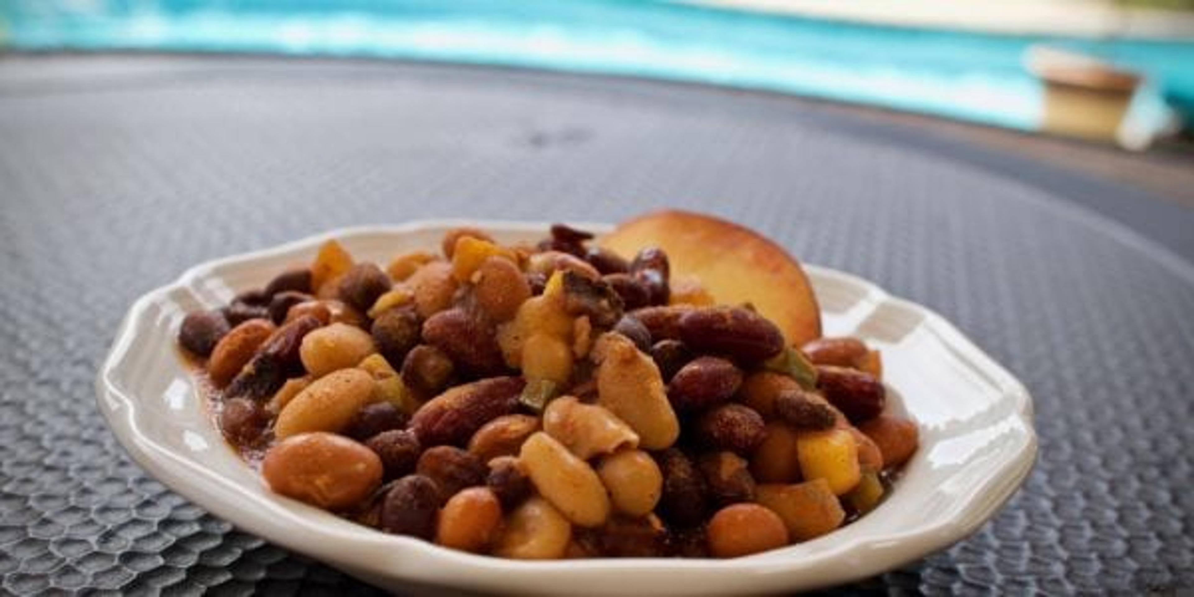 Baked Beans with a Peach Slice on a Table