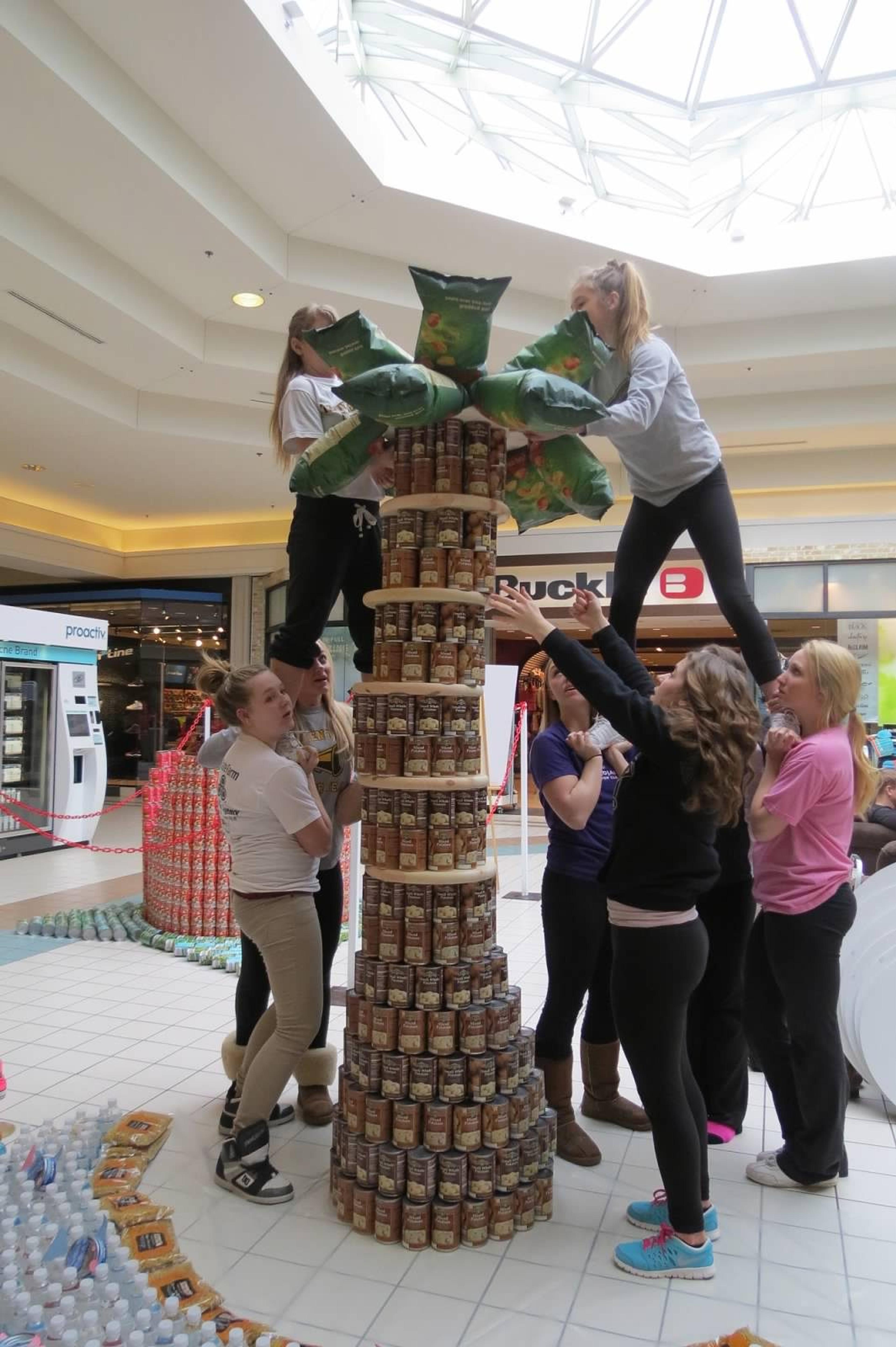 Traverse City Central High School cheerleaders work on their Canstruction exhibit from last year. They're building a castle at this year's event. 