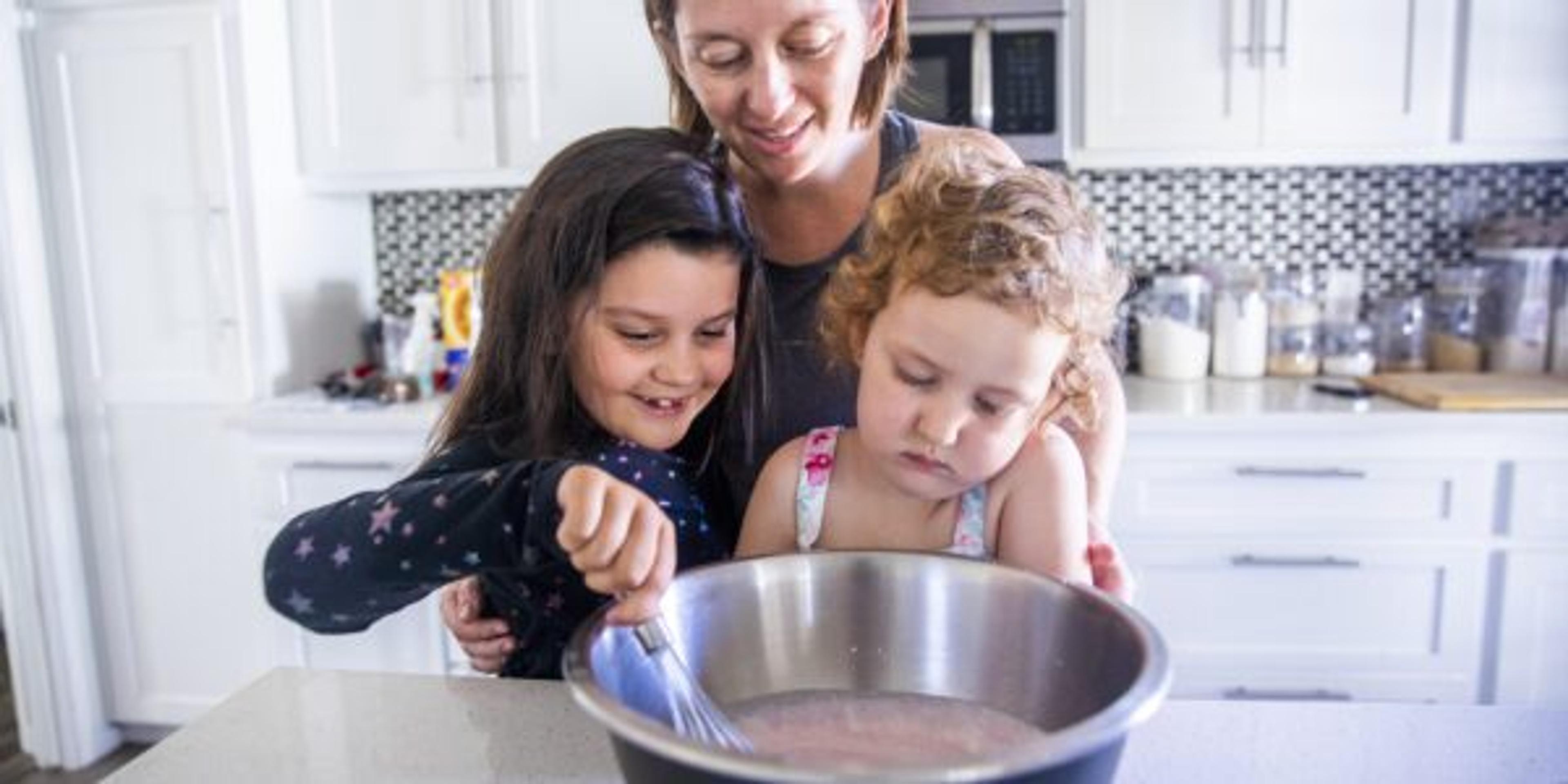 Beautiful Mother Baking with her Young Daughters