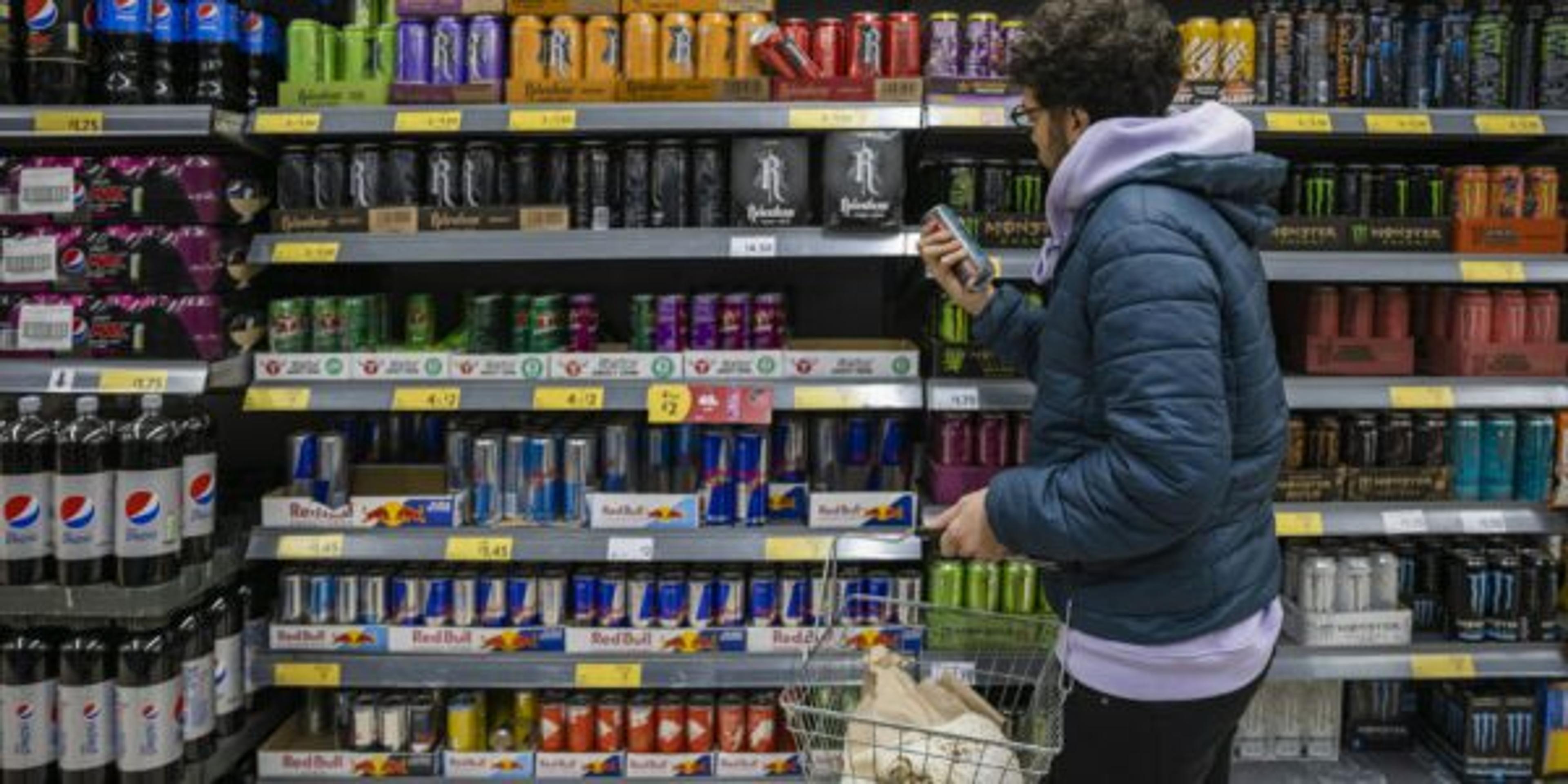 A man shops for energy drinks.