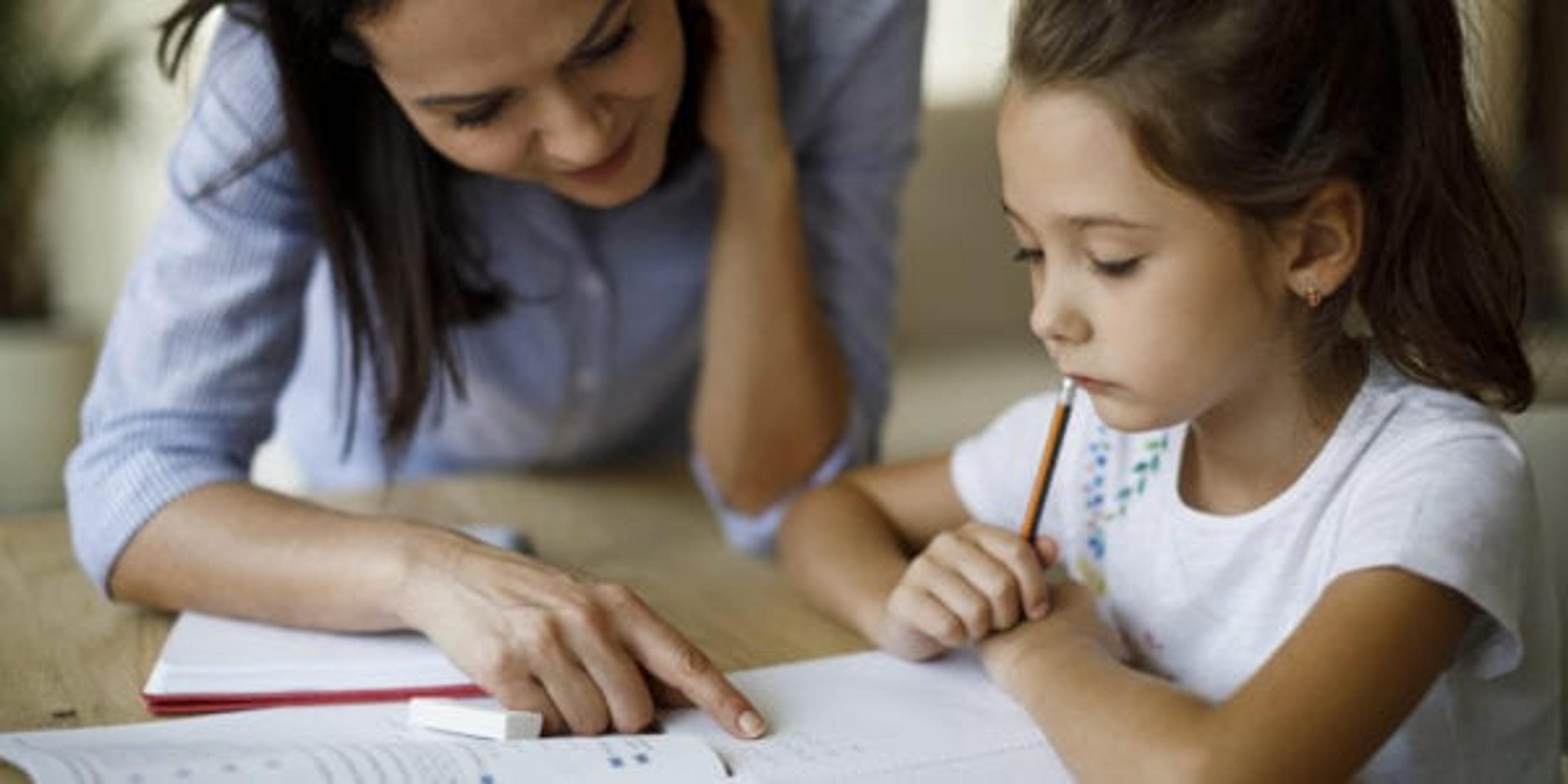 Mother and daughter working homework together