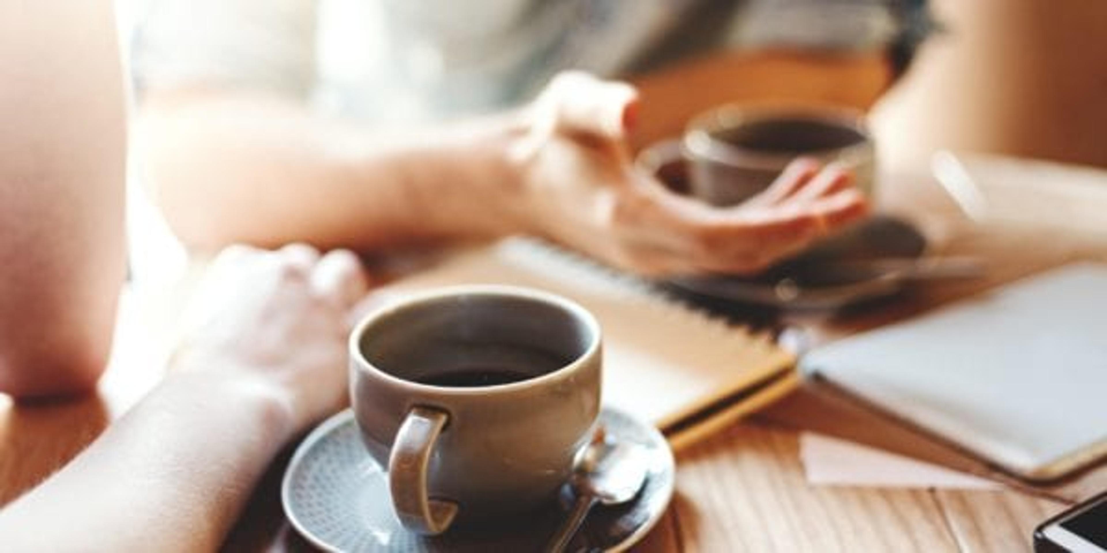 two people at a coffee table having a serious conversation